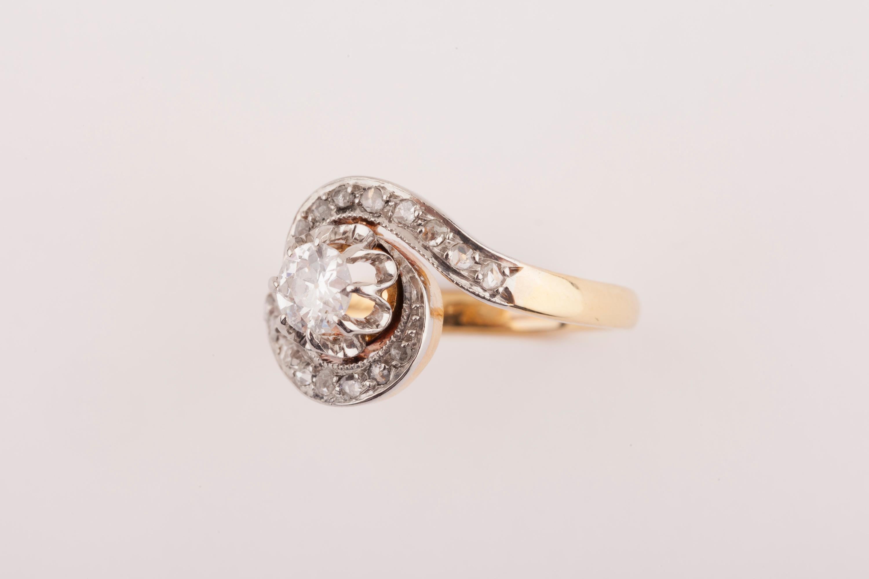 Lovely antique ring, made in France circa 1900. 
Made with gold 18k and Diamonds. The central round Diamond weights approximately 0.40 carats. The diamond is very White and clear. The cut is very good, very good shine.
The total weight of diamond is