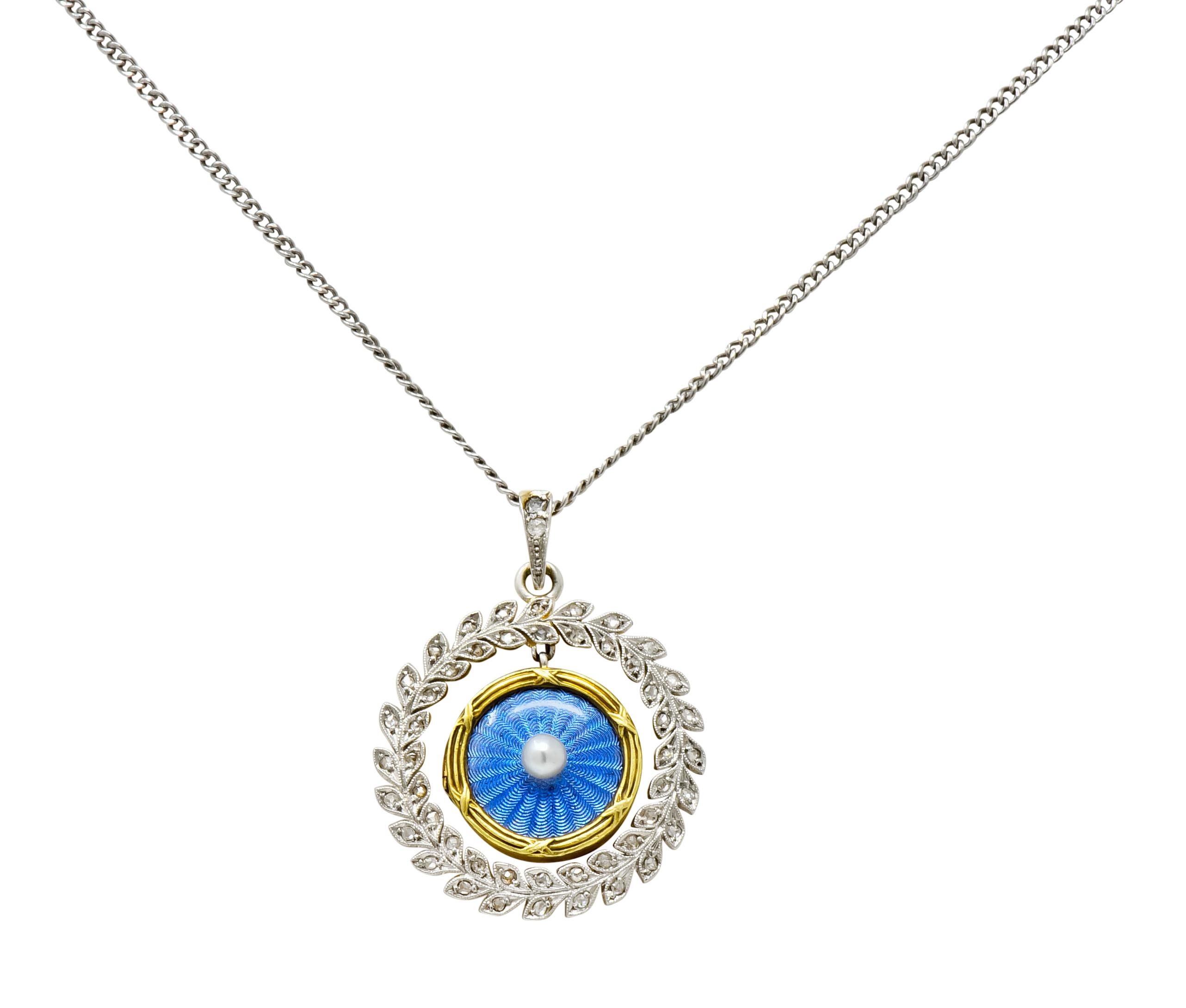 Locket centers a round button pearl measuring approximately 3.0 mm; cream in body color with excellent luster

Surrounded by cornflower blue enamel featuring a scalloped radiating motif encased by glass and a ridged gold surround

Back is clear