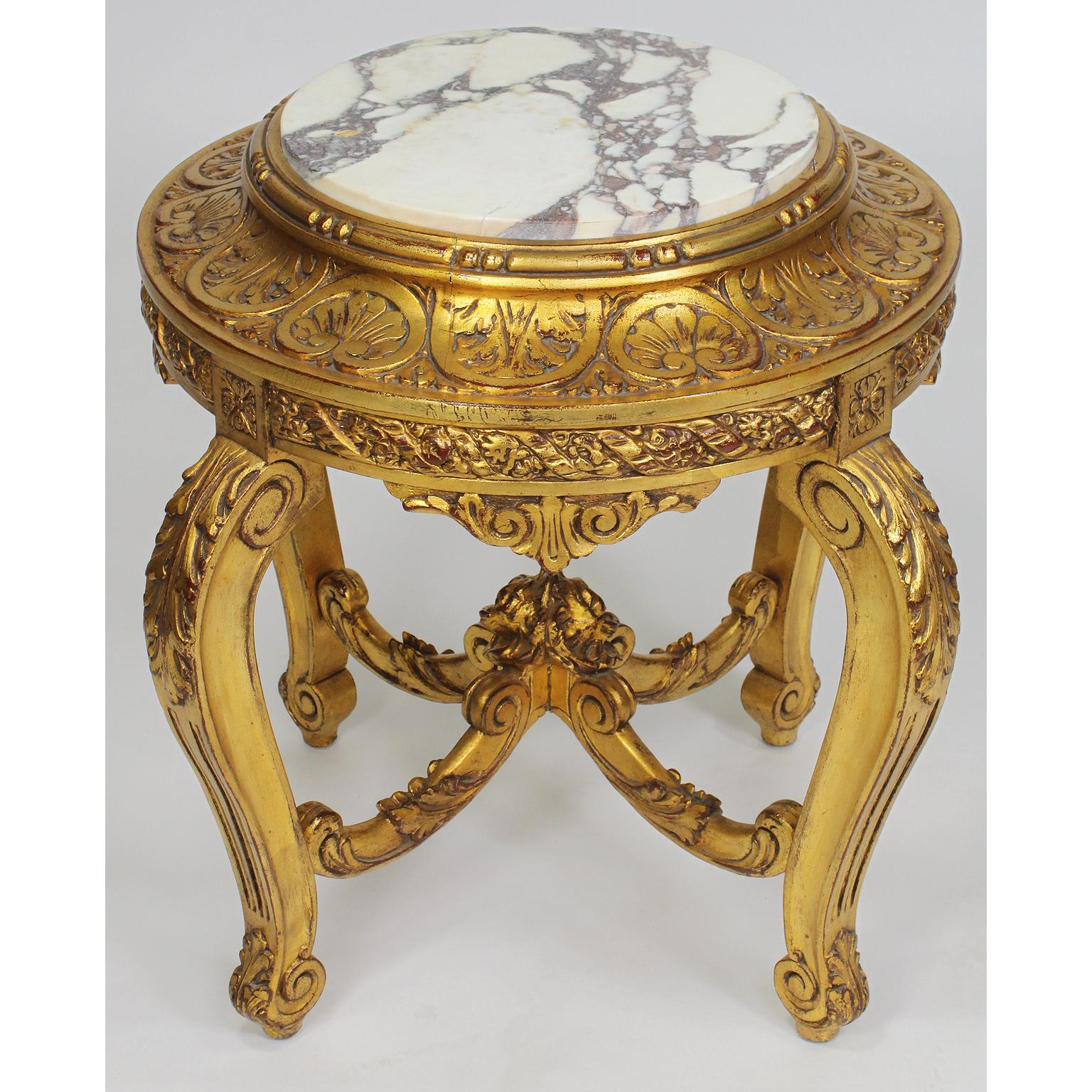 A French belle époque Louis XV style giltwood carved pedestal stand with marble top. The circular pedestal with a carved floral apron depicting flowers and fitted with a veined white marble top, raised on four cabriolet legs conjoined with a center