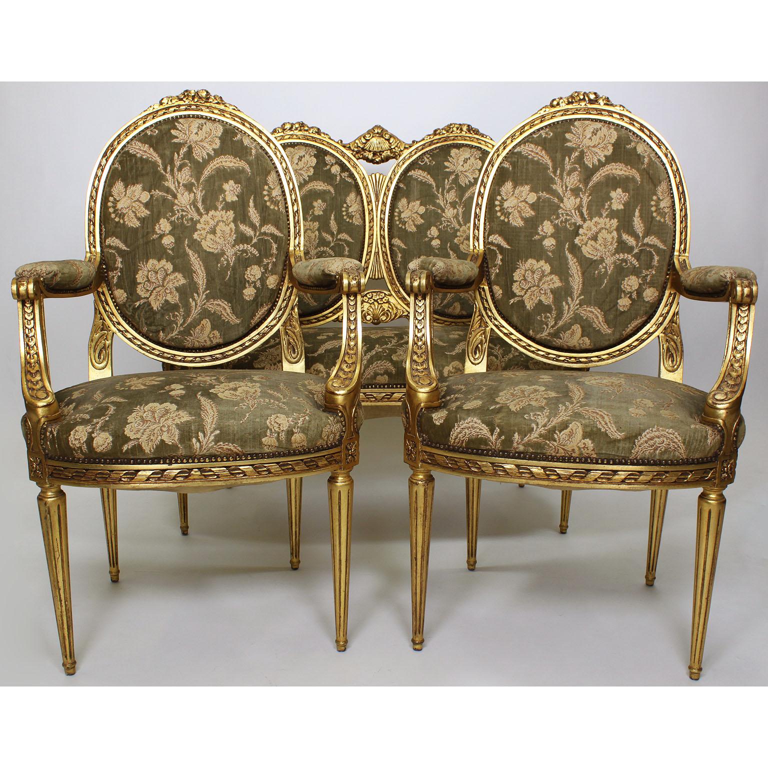 A French Belle époque Louis XVI style giltwood carved three-piece parlor salon suite, comprising of a two-corps canapé (settee) and a pair of fauteuils (armchairs) Paris, circa 1900.

Measures: Settee height: 42 1/2 inches (108 cm)
Settee width: