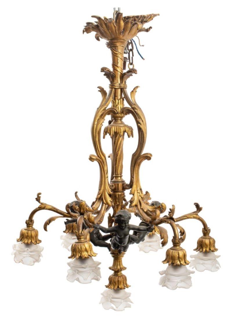 French Belle Epoque ormolu chandelier with scrolling foliage and three floating bronze putti, with floral petal shaped glass shades. Measures: 36