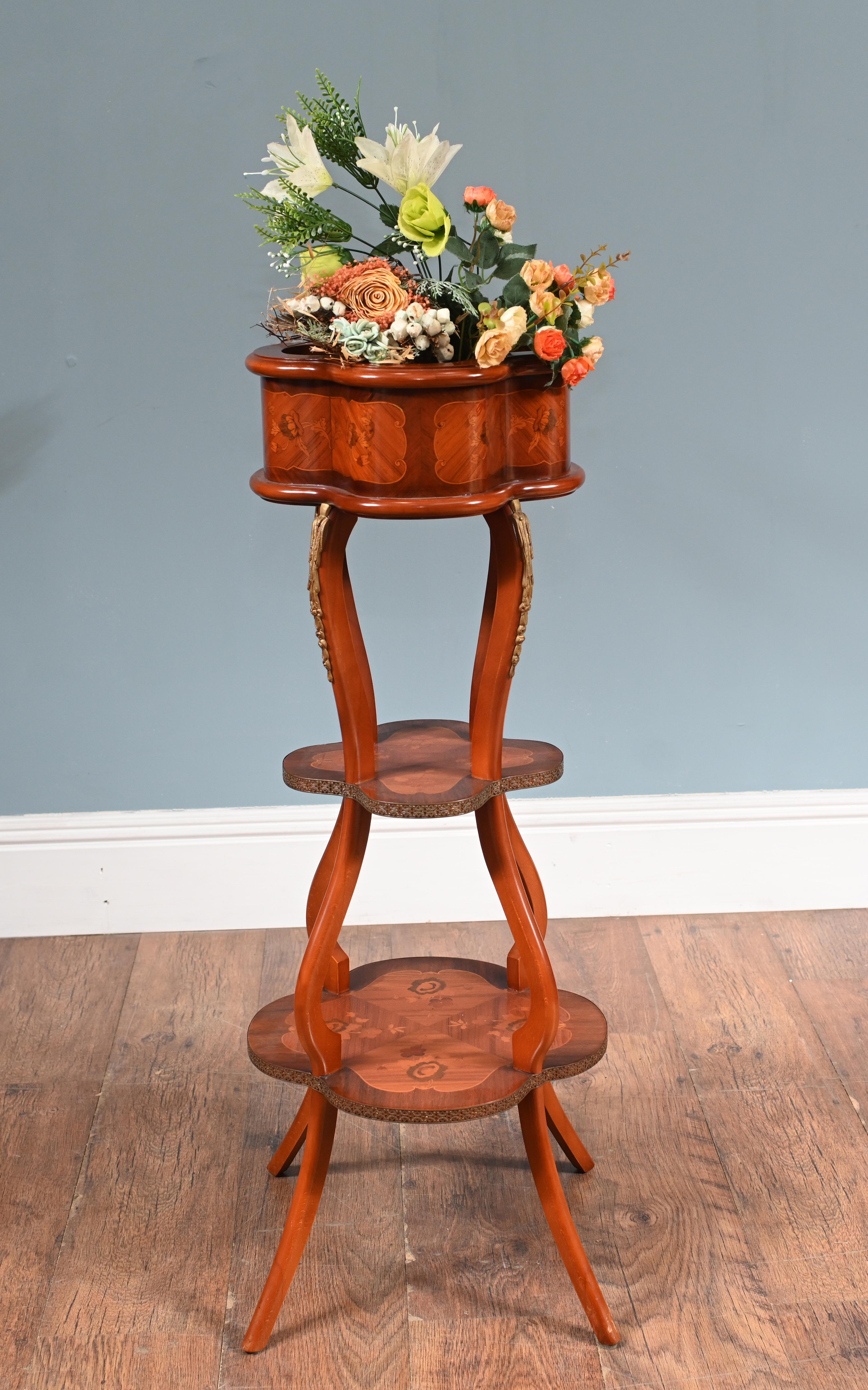 You are viewing a gorgeous vintage Belle Époque jardinière Circa 1930
The uppermost tier is a scalloped or lobed container, likely
originally intended to hold a planter or porcelain liner
It features inlaid marquetry panels with floral motifs and