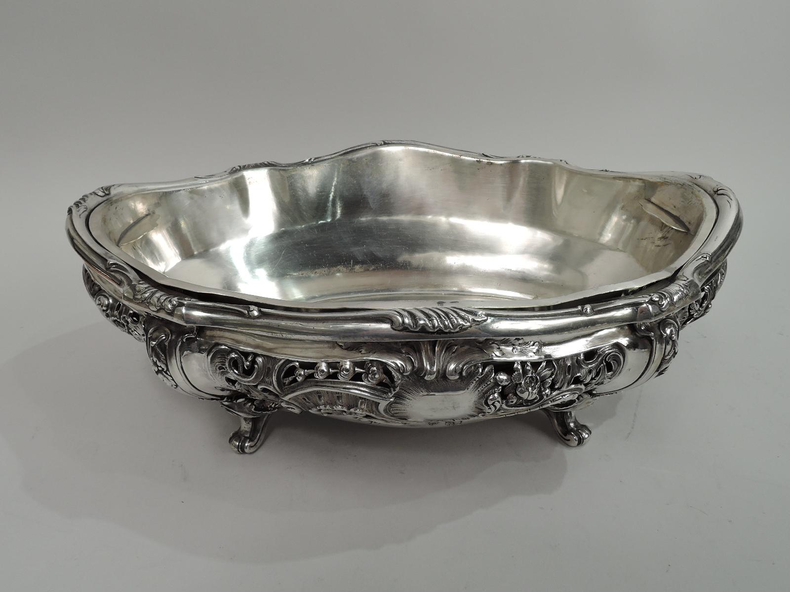 Belle Epoque Rococo 950 silver jardiniere. Made by Edmond Tetard in Paris, ca 1890. Shaped oval well. Bellied and open sides with flowers, leafing scrollwork and diaper. Four leaf and flower-mounted scroll supports. A fresh and dynamic centerpiece