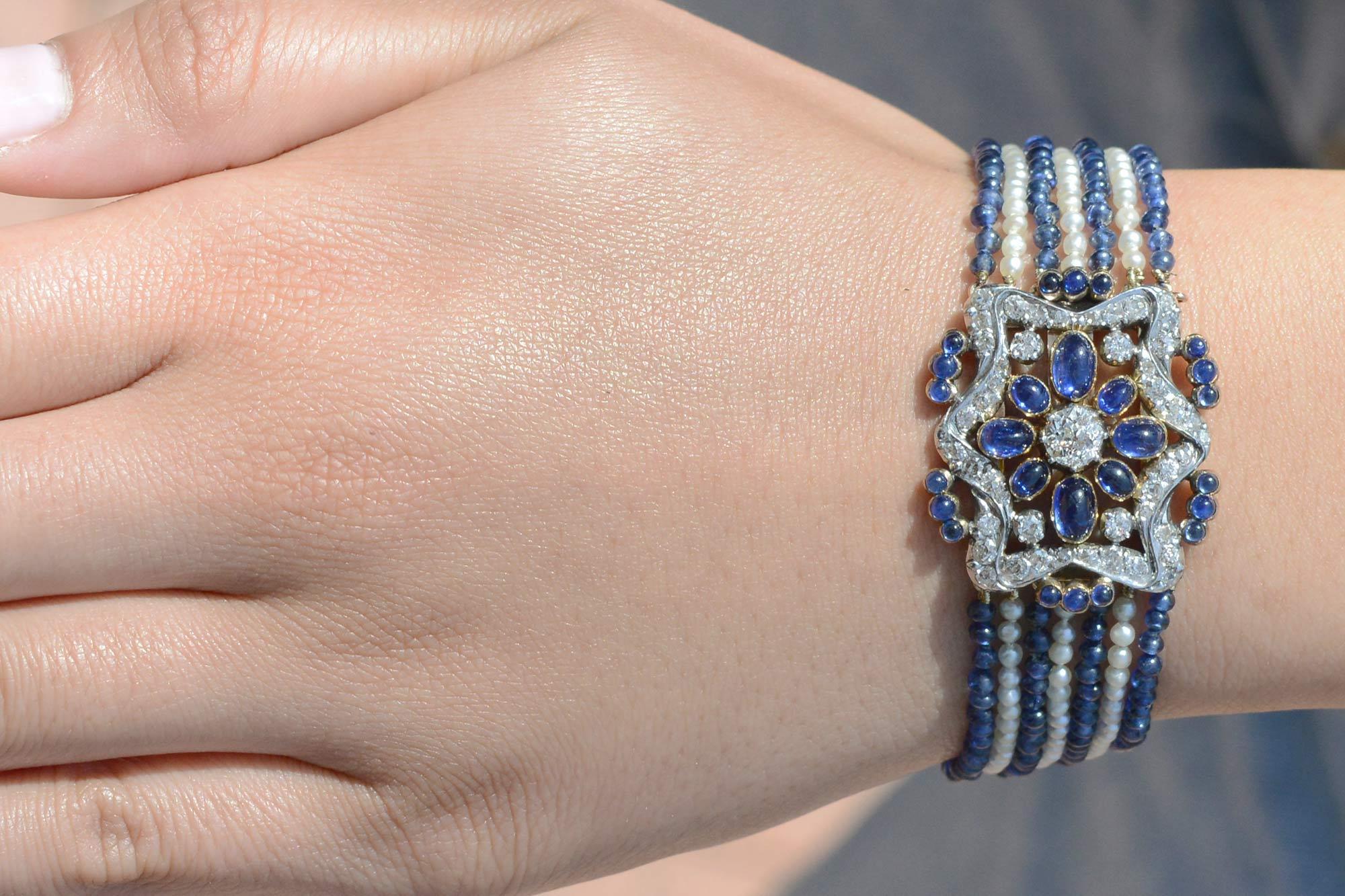 A resplendent member of history, this authentic Belle Époque bracelet is complete with French hallmarks providing an over 100 year old provenance. The seven alternating strands of seed pearls and sapphire beads leading to a decorative star medallion