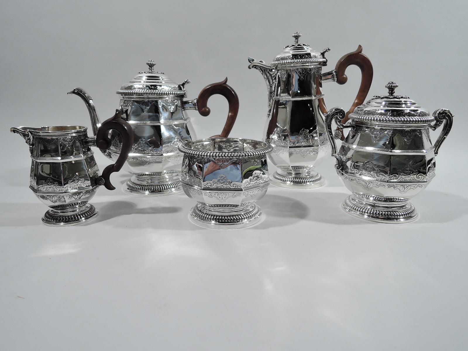 Belle Époque 950 silver coffee and tea set. Made by Emile Puiforcat for Tiffany & Co. in Paris. This set comprises 5 pieces: Coffeepot, teapot, creamer, sugar, and waste bowl. Each: Faceted and girdled upward tapering body on raised foot. Covers