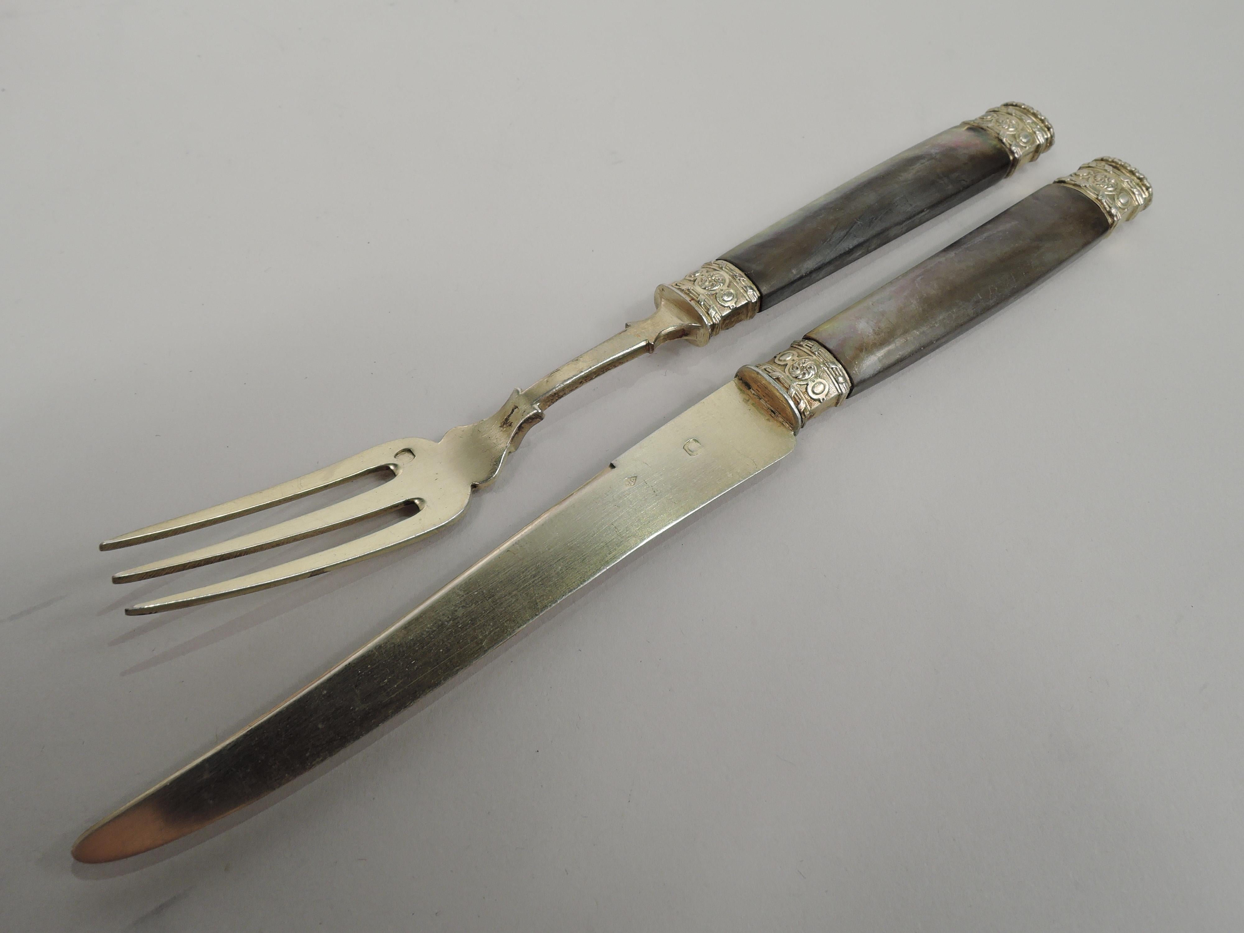 Turn-of-the-century Belle Epoque 950 silver and mother of pearl fruit set. Made by Gustave Veyrat in France. This set comprises 24 pieces with 12 forks and 12 knives. Each: Mother of pearl handle with ornamented mounts and lobed oval terminal with