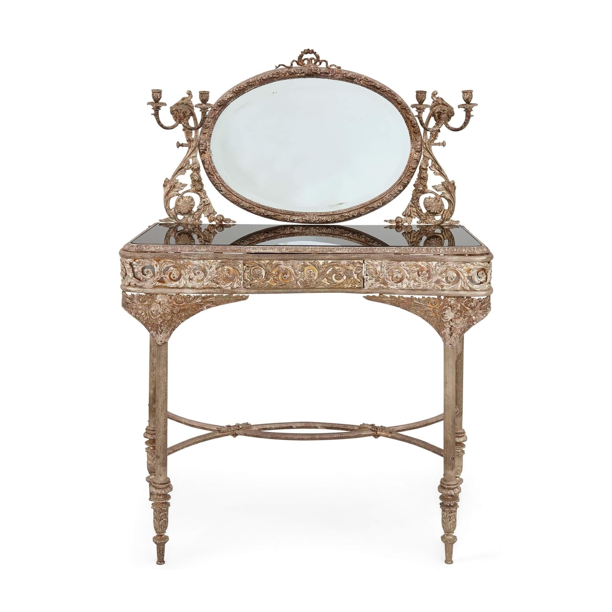 French Belle Époque silvered bronze vanity table
French, late 19th Century
Height 130cm, width 90cm, depth 46cm

This elegant dressing table is crafted from silvered bronze in the Baroque style. The painted glass tabletop of the table is supported