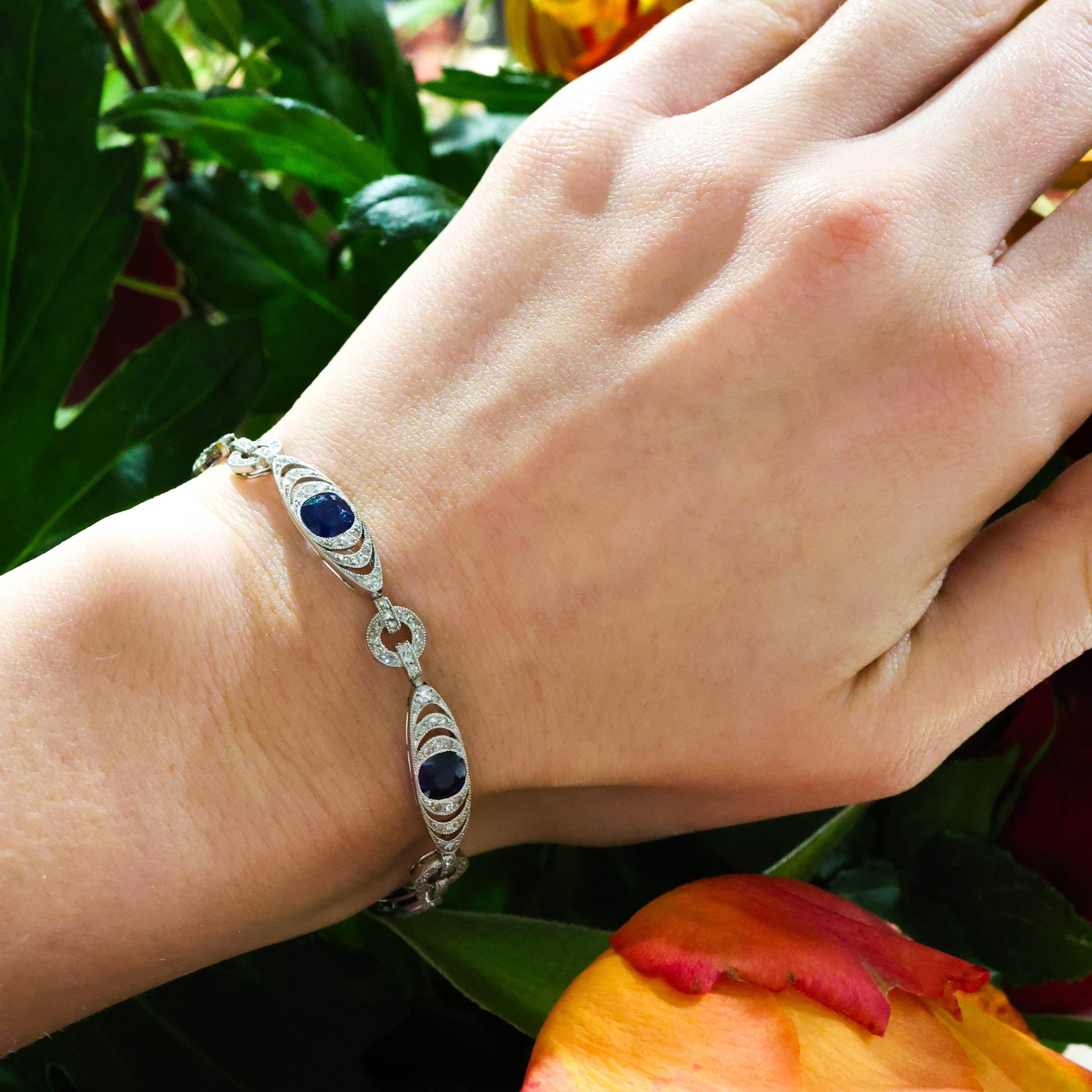 A French Belle Époque Thibault & Jolivot sapphire, diamond and platinum bracelet, comprising long oval links, with central cushion shaped sapphires, with three rows of open work eight-cut diamonds in grain settings, with millegrain edges, onto links