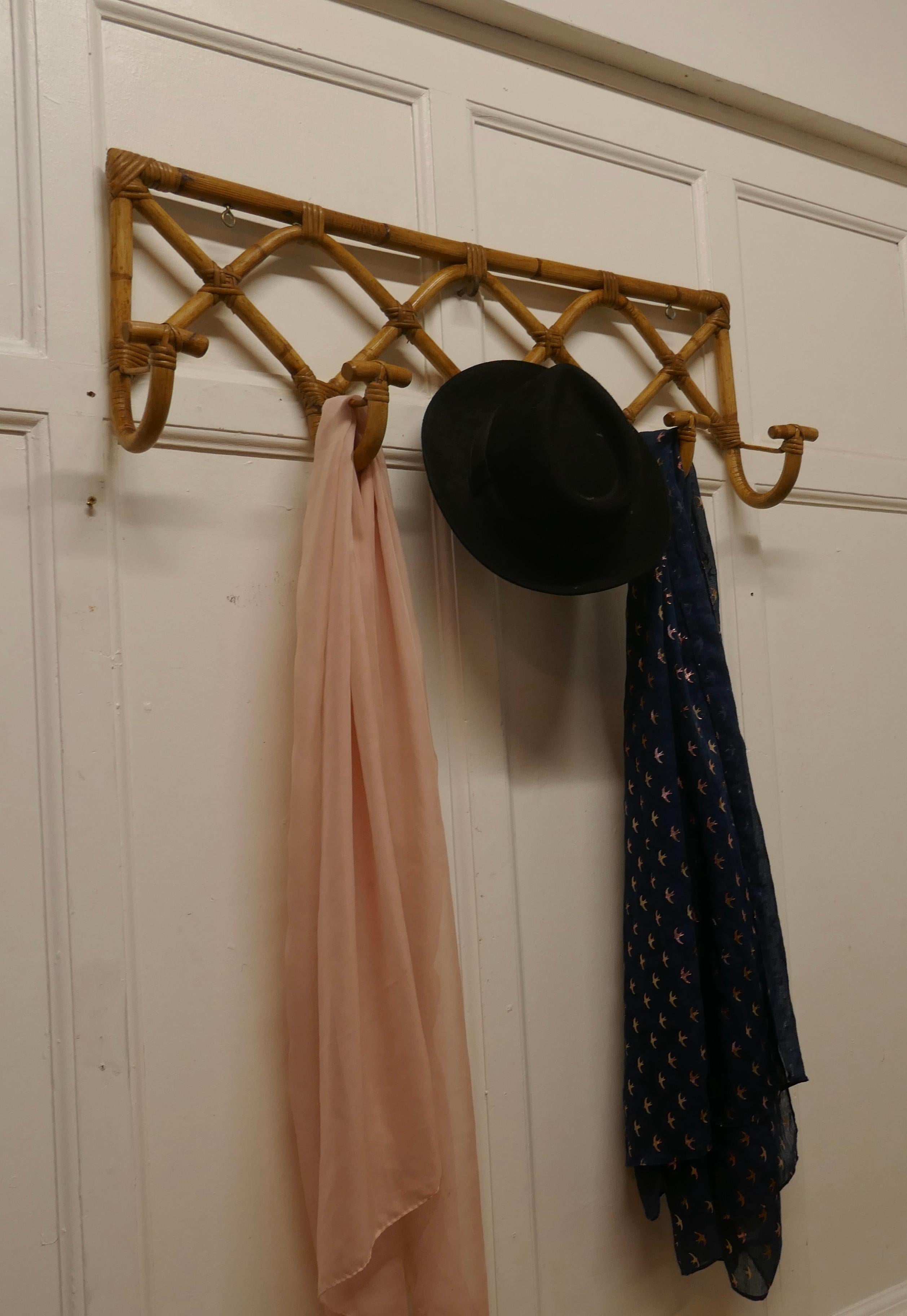 French bent bamboo hat and coat rack

This is an unusual piece it is a wall hanging piece, it has 5 T shaped coat hooks for coats or hats it would make a good hall piece and anywhere where space is limited
This a good looking piece in a Retro