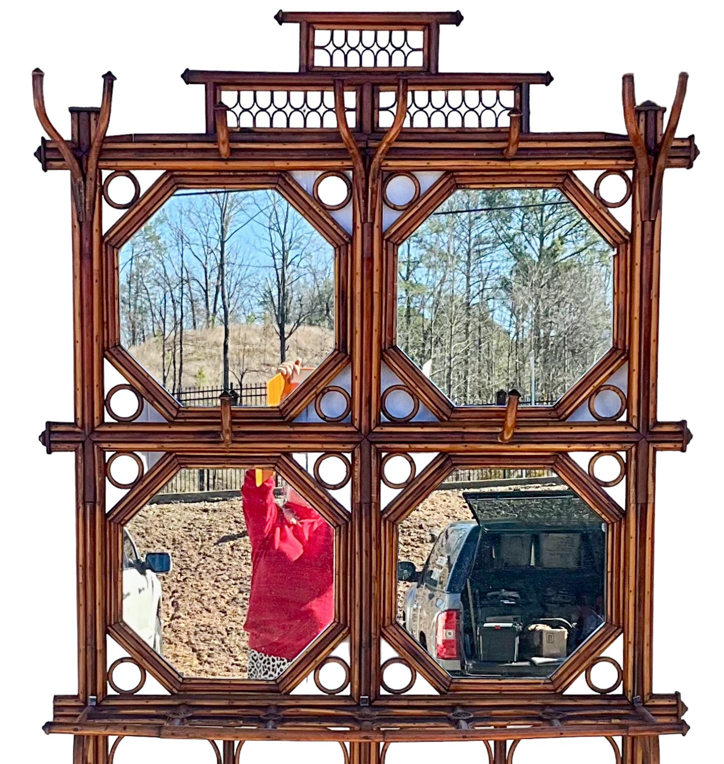 This is one of my favorite hall trees! It is a 1950s French bent bamboo piece. It has four octagonal mirrors, multiple hooks and a lined base for umbrellas. It is in very good condition with only some minor wear to the cane along the base. It is