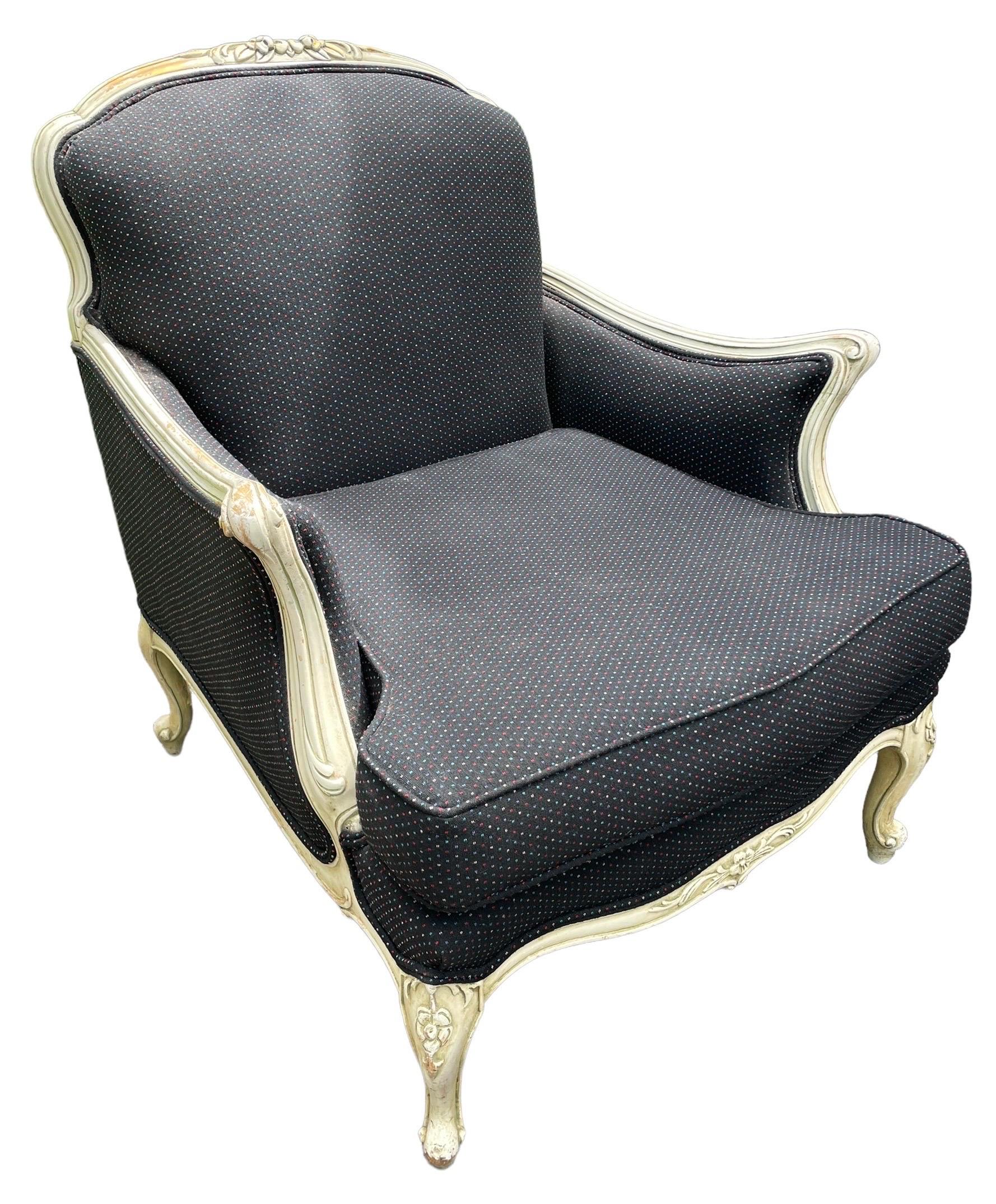 A painted and upholstered French Bergère chair having flared arms circa 1930. Newly Reupholstered. Gorgeous navy patterned fabric and a gorgeous classic accent chair.