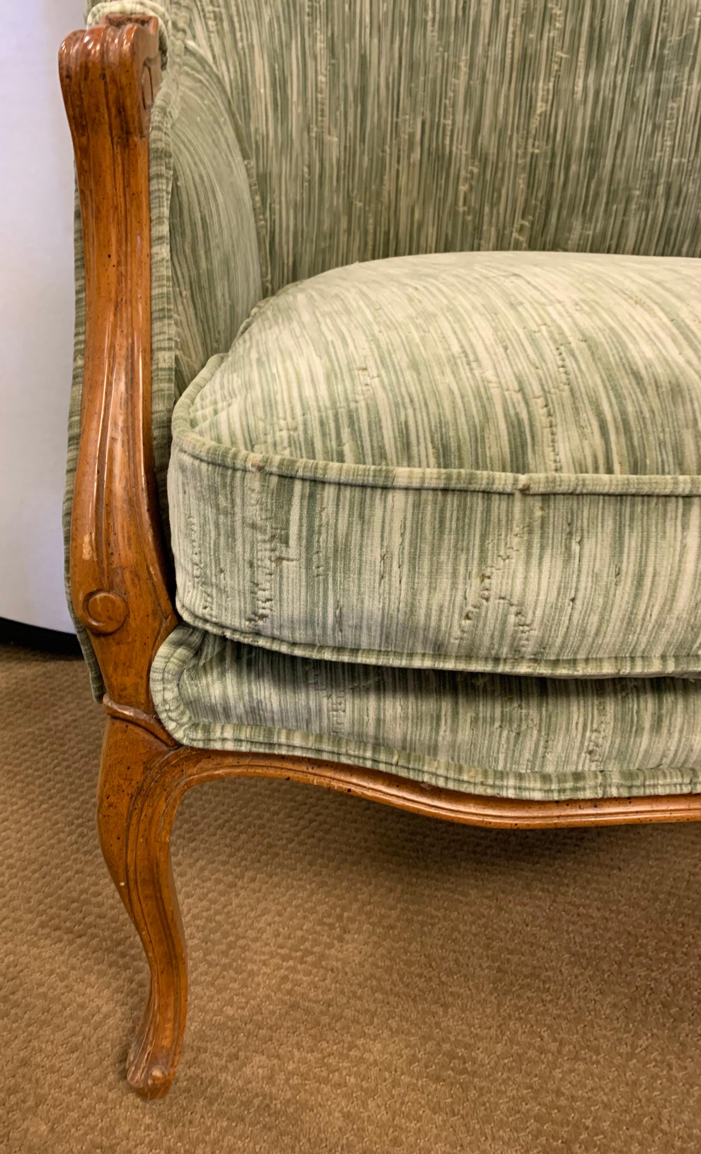 Stunning vintage French bergère walnut chair newly reupholstered in the most luxurious Clarence House crushed velvet fabric that has subtle tree forms built into the fabric. Must be seen to be appreciated. Now, more than ever, home is where the