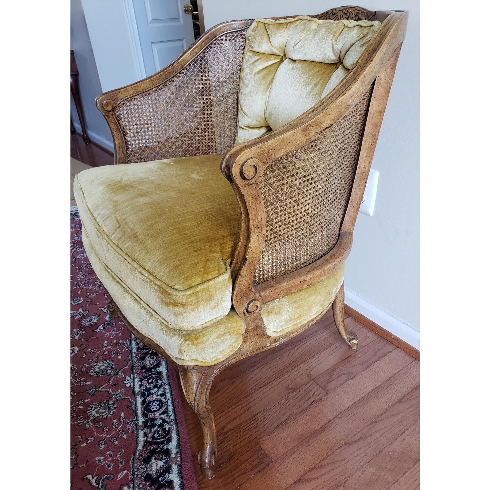 Vintage French caned Bergere armchair with carved crest rail and dainty cabriolet legs. 
Yellow Mustard velvet upholstery in very good condition.
Comes with removable seat cushion
Measures 25.5
