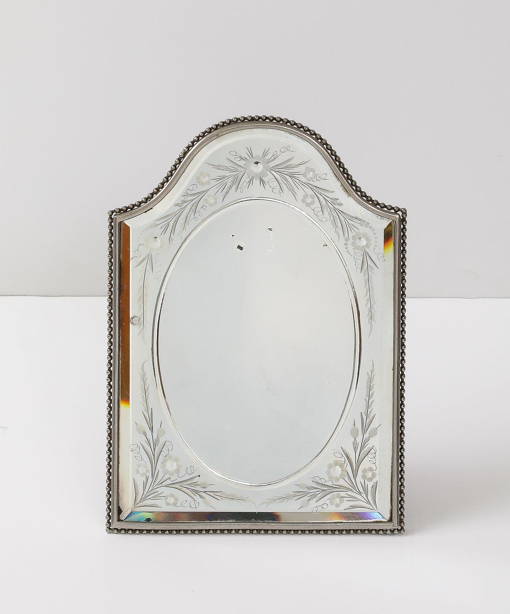 A truly exquisite French vanity table mirror, perfect for adding a touch of vintage elegance to your dressing area. This mirror features a beautifully hand-cut and etched floral design, showcasing delicate craftsmanship and artistry. The intricate