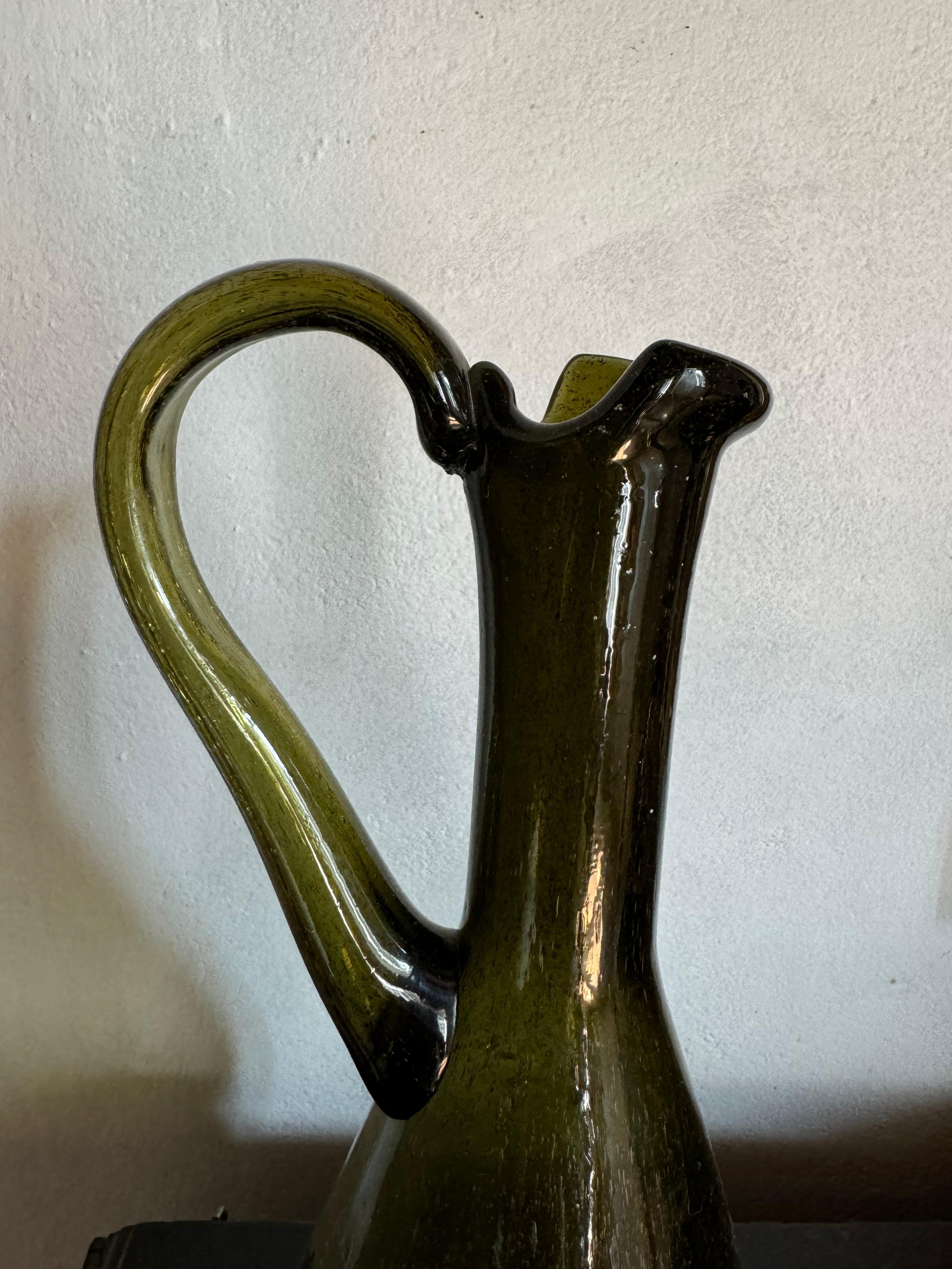 A beautiful handblown bubble glass carafe pitcher atttibuted to Biot.