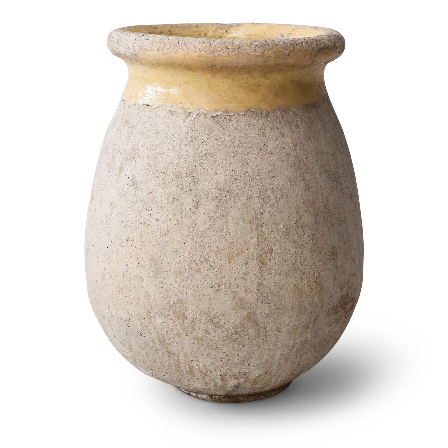 French Biot jar dating to the mid-late 19th century. Rounded shapely body with a rolled-edge yellow-glazed lip.