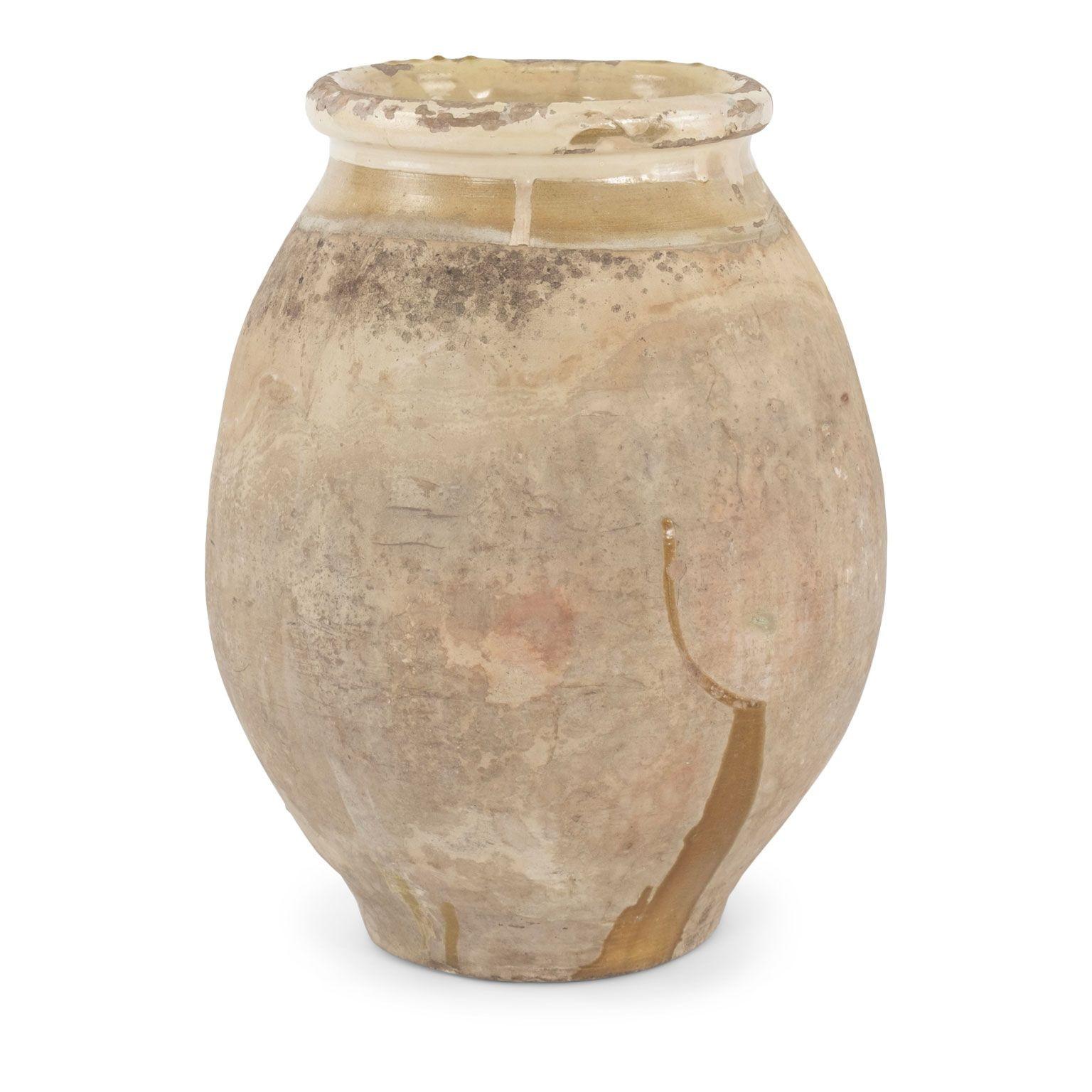 French Biot jar with yellow glazed rim dating to the Mid-19th century. Nice patina and pitted surface from decades of natural wear and use.