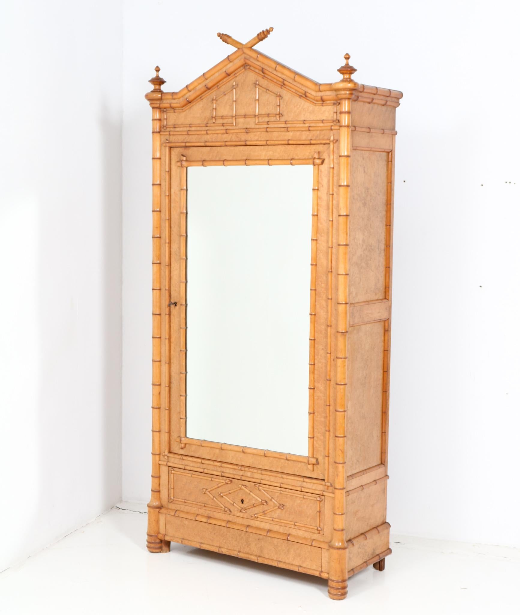 Magnificent and ultra rare French Provincial armoire or wardrobe.
Striking French design from the 1900s.
Executed in birds-eye maple and faux bamboo, this stunning piece of craftsmanship is a true example of the exciting decorative changes that