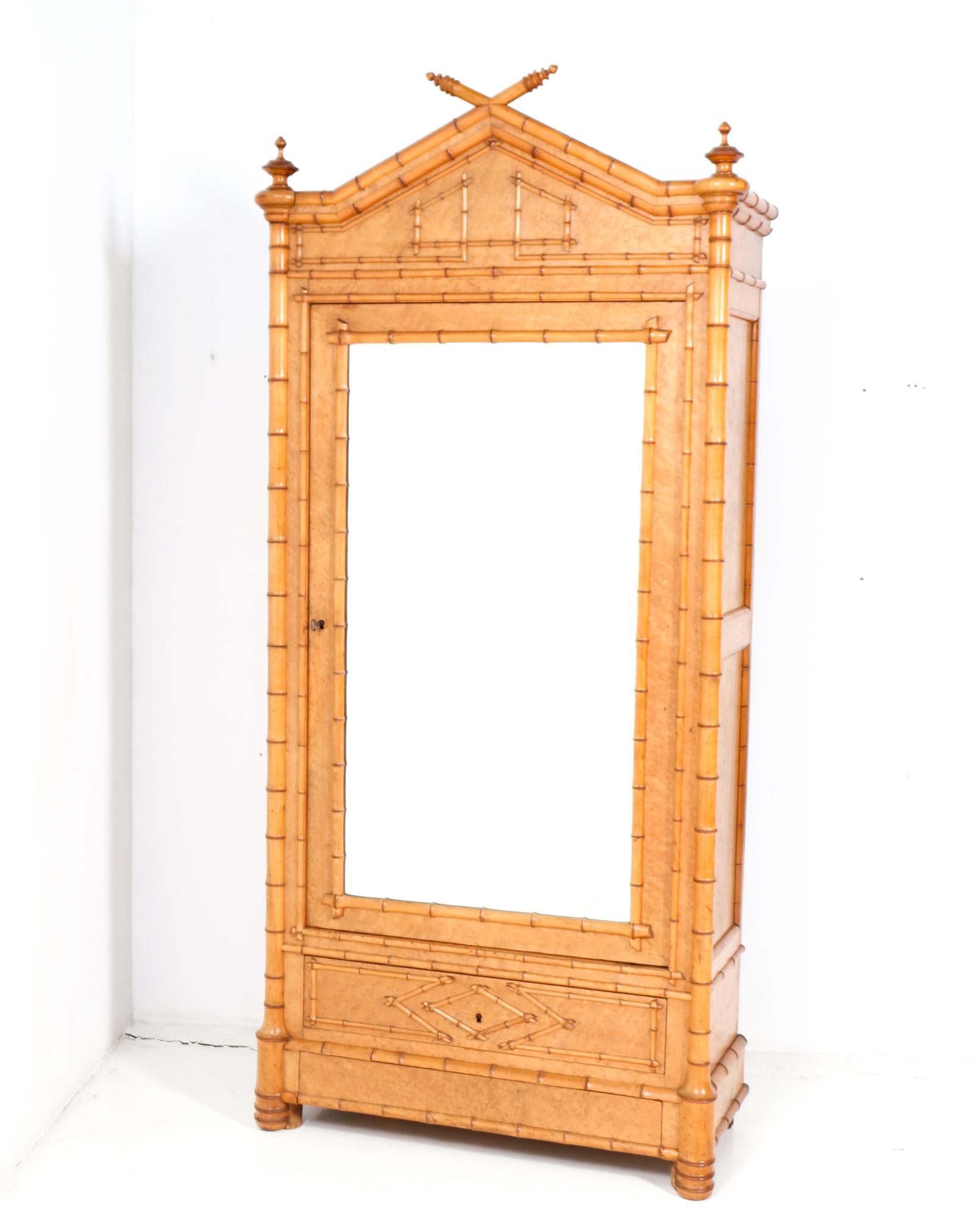 Magnificent and ultra rare French Provincial armoire or wardrobe.
Striking French design from the 1900s.
Executed in birds-eye maple and faux bamboo, this stunning piece of craftsmanship is a true example of the exciting decorative changes that came