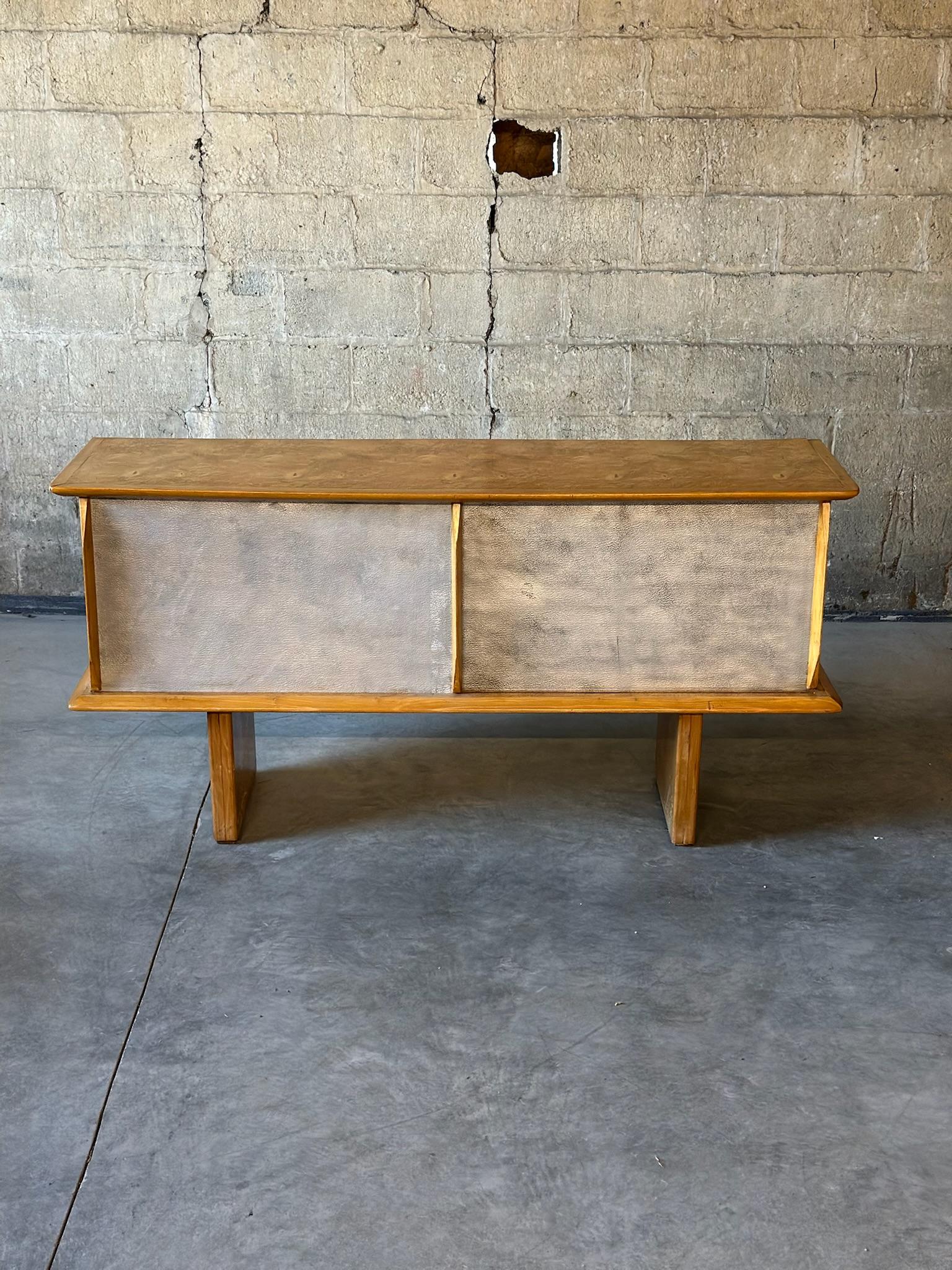 A vintage French sideboard of birds eye maple & chromed tin. In the style of the French designer Guy Lefevre. Clean lines and minimalist design. Interior provides ample storage and chromed tin doors make it extra unique & special.