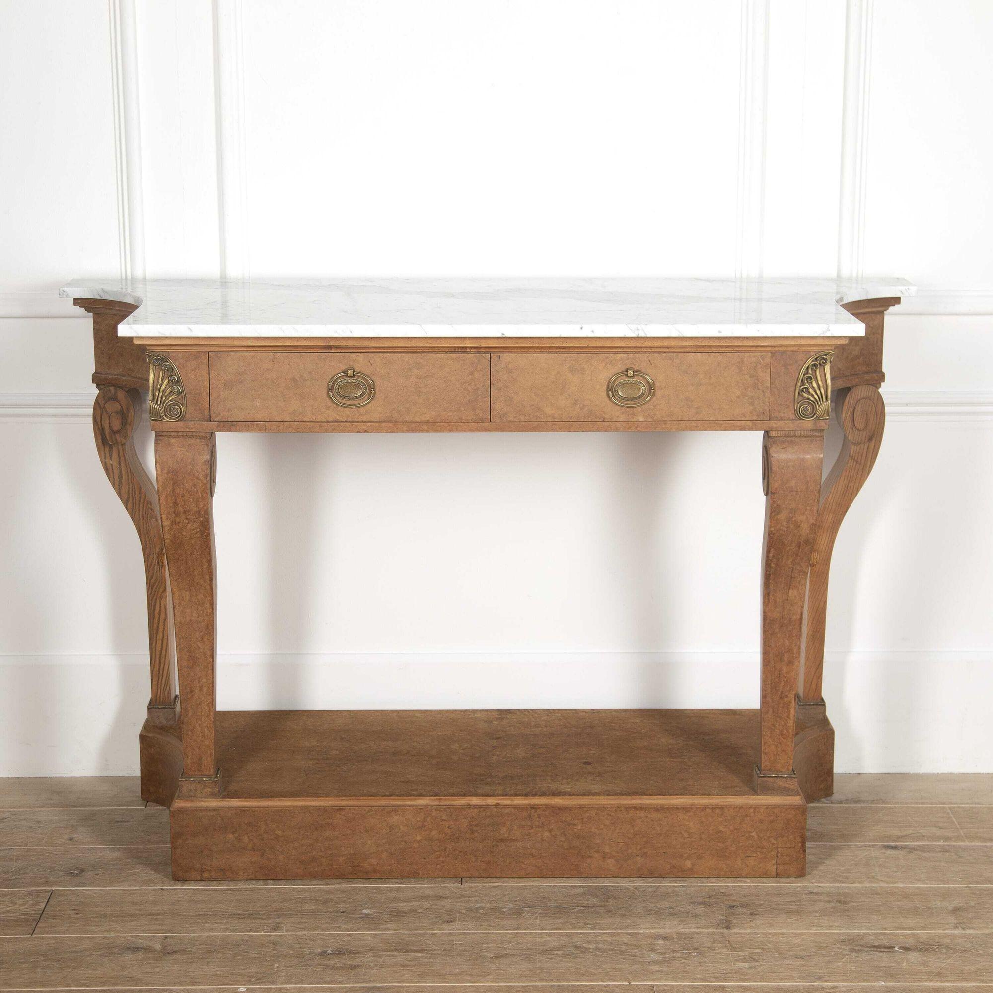 Very elegant French 20th Century bird's-eye maple console table.
This pretty console features a shaped white Carrara marble top over two frieze drawers with decorative handles and ormolu mounts to either side. 
Supported on tapering front supports