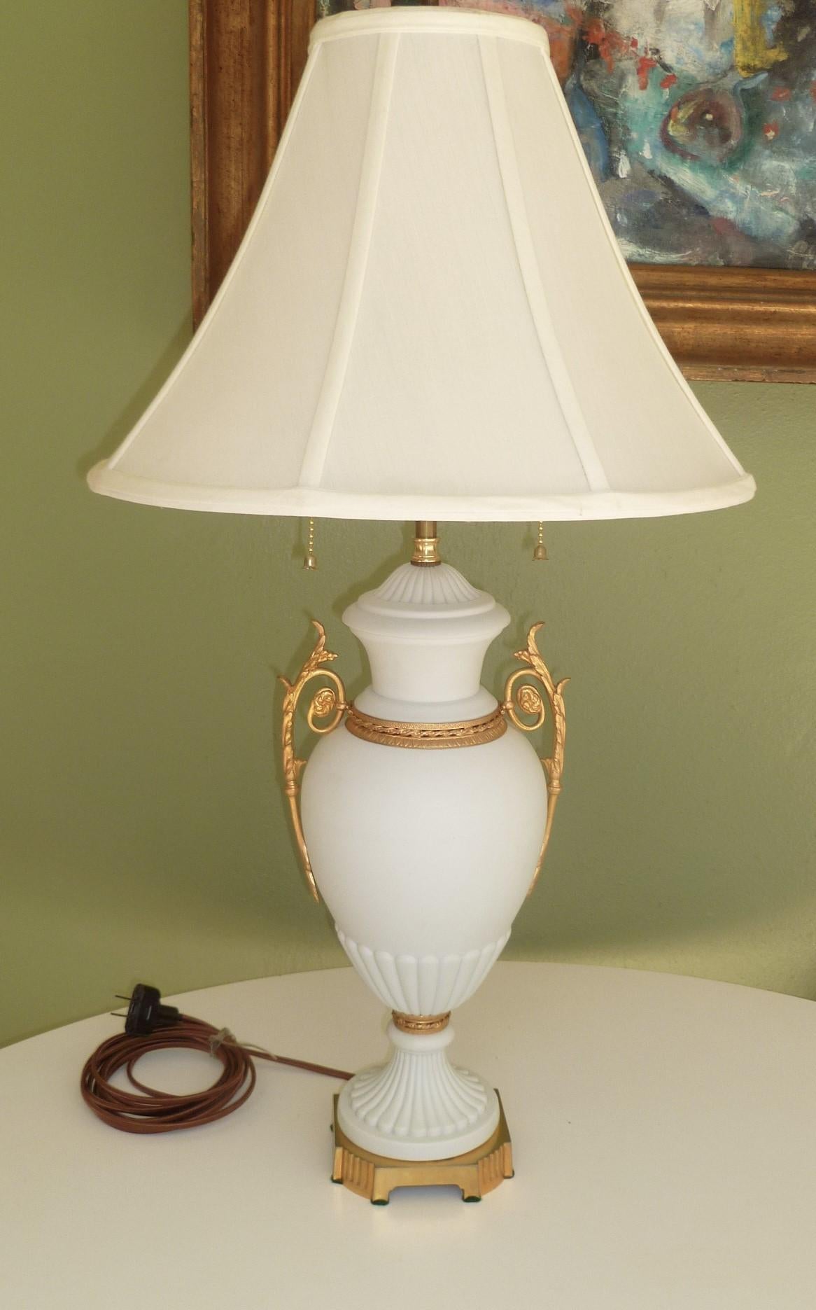 REDUCED FROM $950....A Bisque Parian porcelain classical urn with finely chased gilt bronze ormolu handles, base and mounts, finished as a double socket table lamp. The matte finish of the porcelain is exquisite. Stamped made in France on the inner