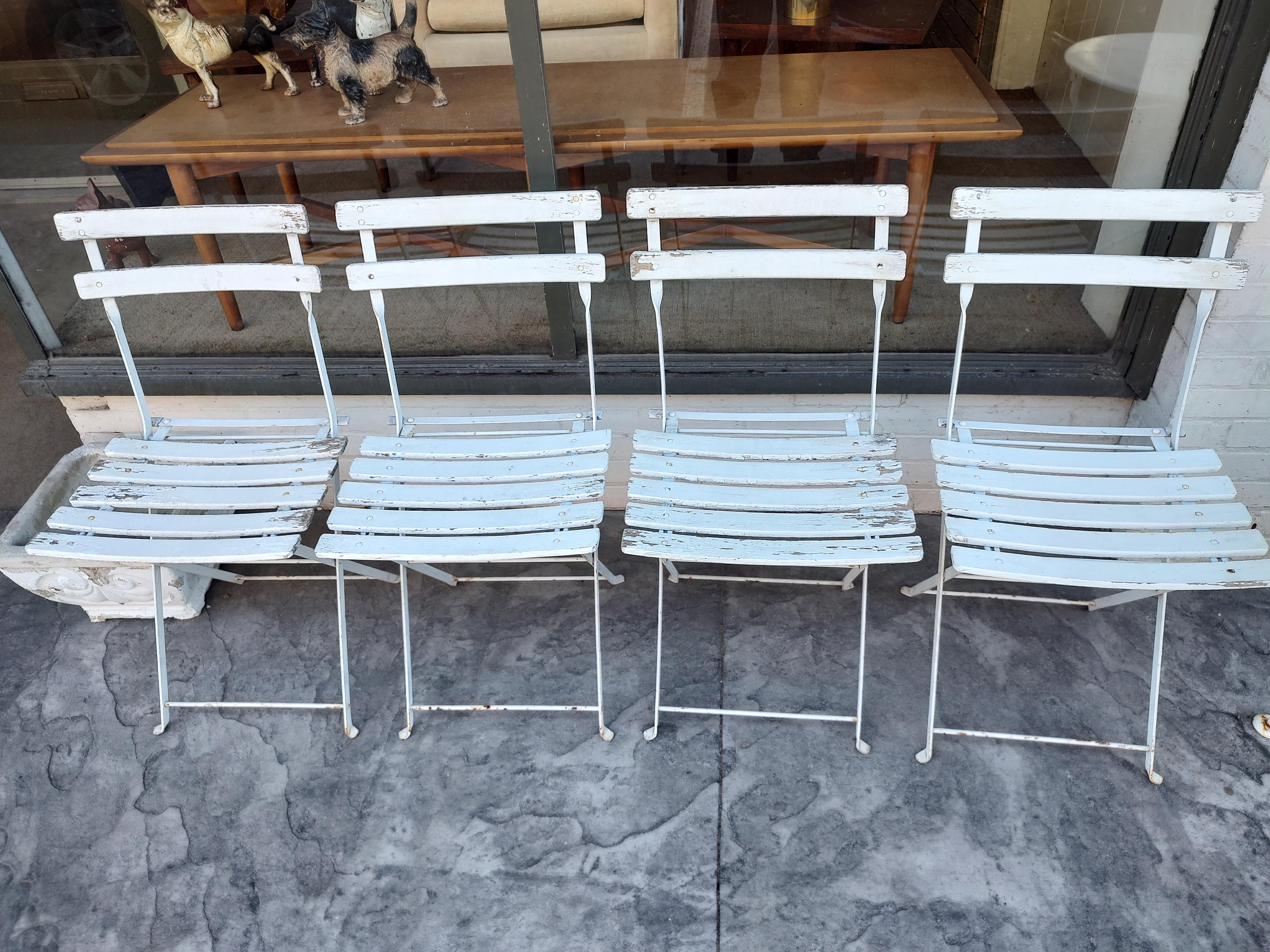 Shabby chic outdoor cafe bistro 5 piece set of iron and Slatted wood chairs and a 24 diameter metal table. Everything works well, chairs fold and are sturdy. Table does fold, and is stable. Top has been sanded and sprayed white. 