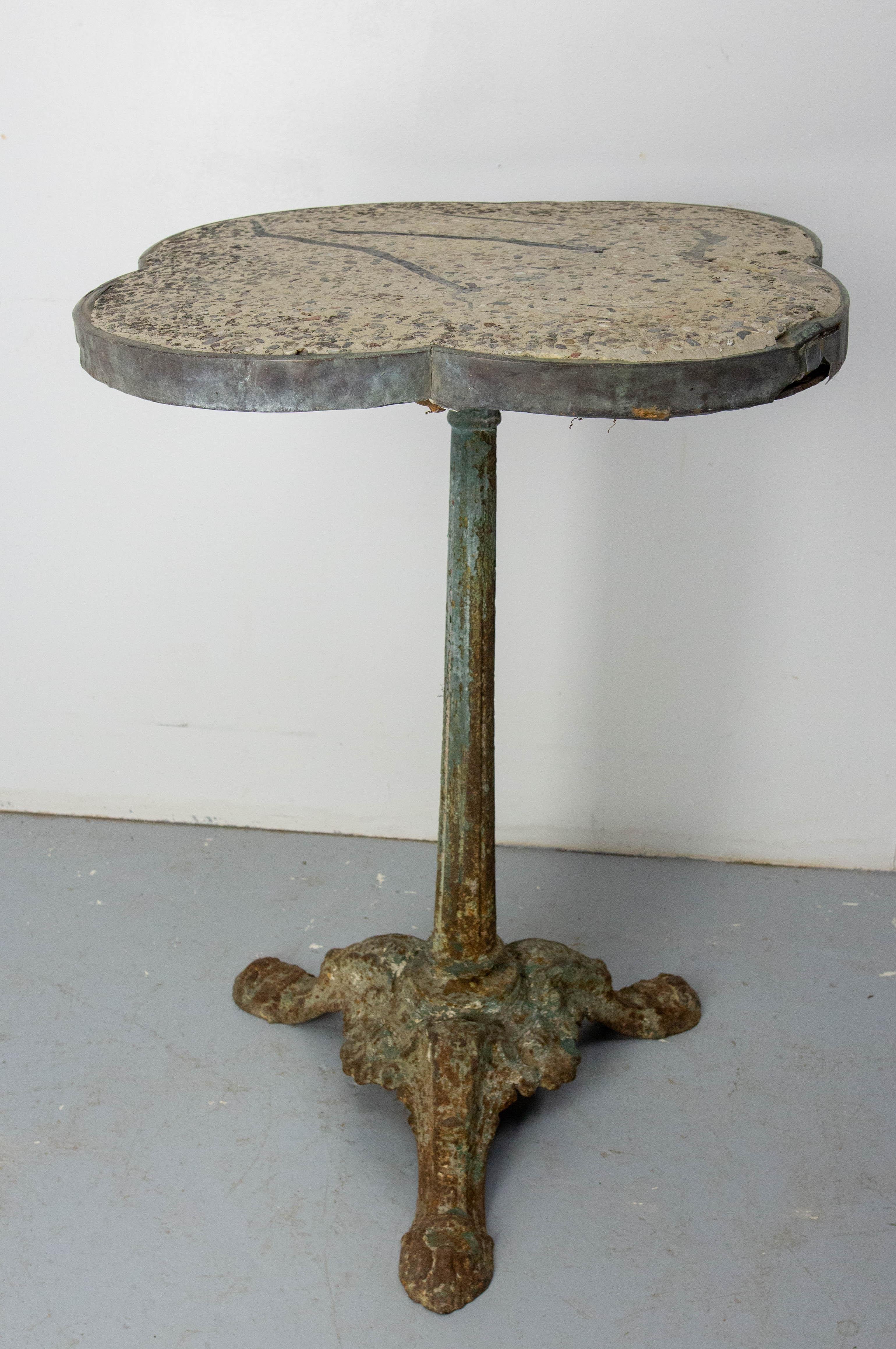 Bistro tables with terrazzo top and wrought iron foot, French, circa 1900 in the art Nouveau period. This authentic bistro table was frequently used in guinguettes. The guinguette, originating in the 17th century, was a type of popular tavern in the