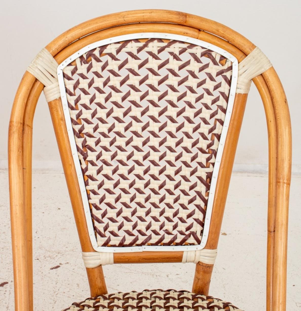 Set of four French Parisian Bistro style bentwood Chairs, the arched woven plastic back and seat, raised on bamboo legs, joined by an X-form stretcher, circa late twentieth century. Set of Four.

Dimensions: 34.5