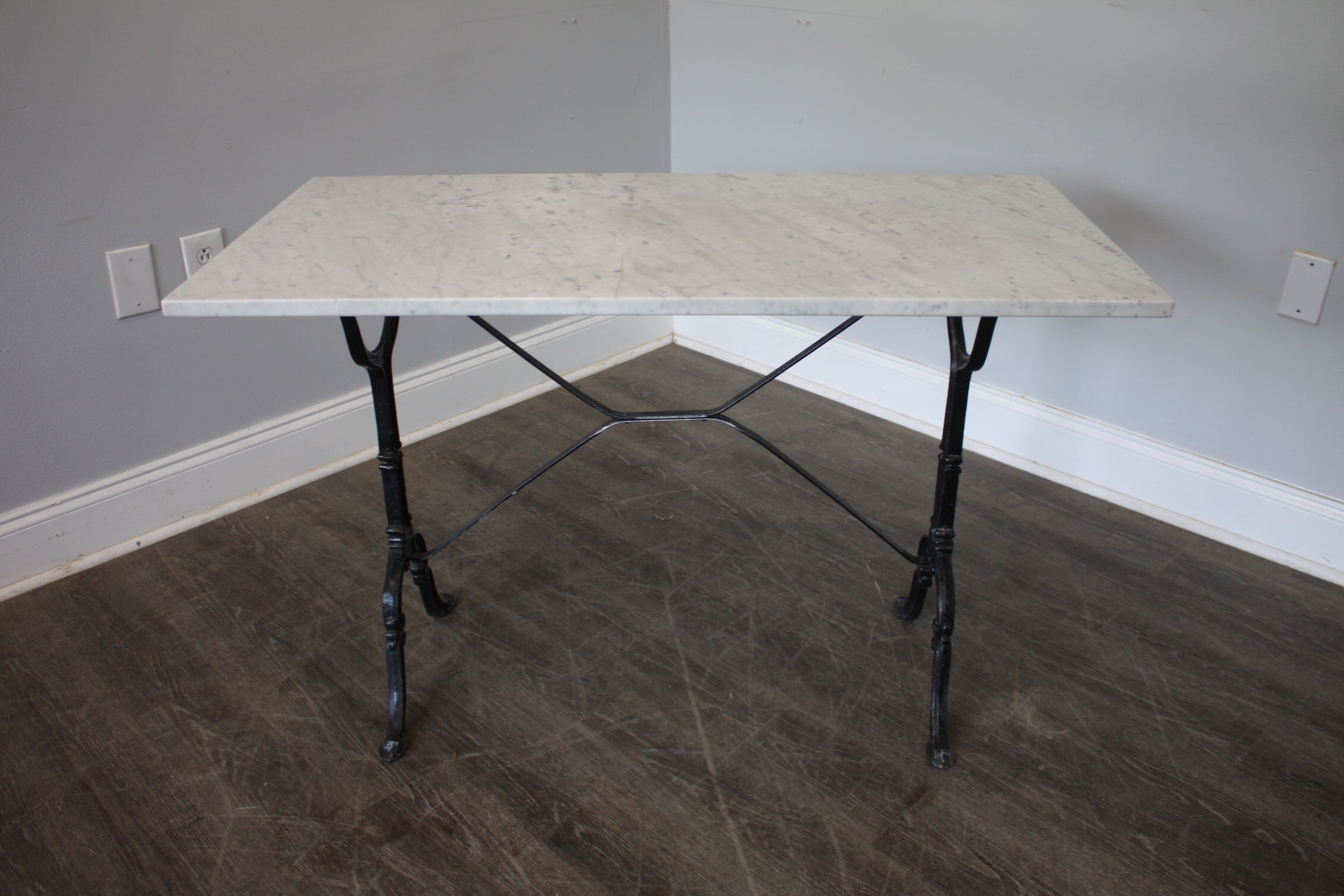 This Bistro Table can be use either inside or outside. It is made of cast iron black lacquered and a white marble top.