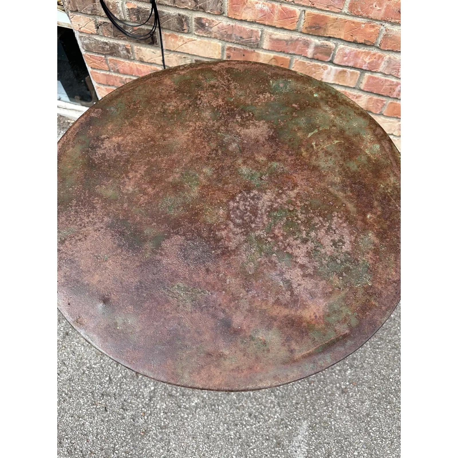 This is a great little all original French bistro table from the early 1900s with a solid iron base metal top and faded green paint. It's easy to tell this is an original condition. This table is in great condition with many years of life ahead of