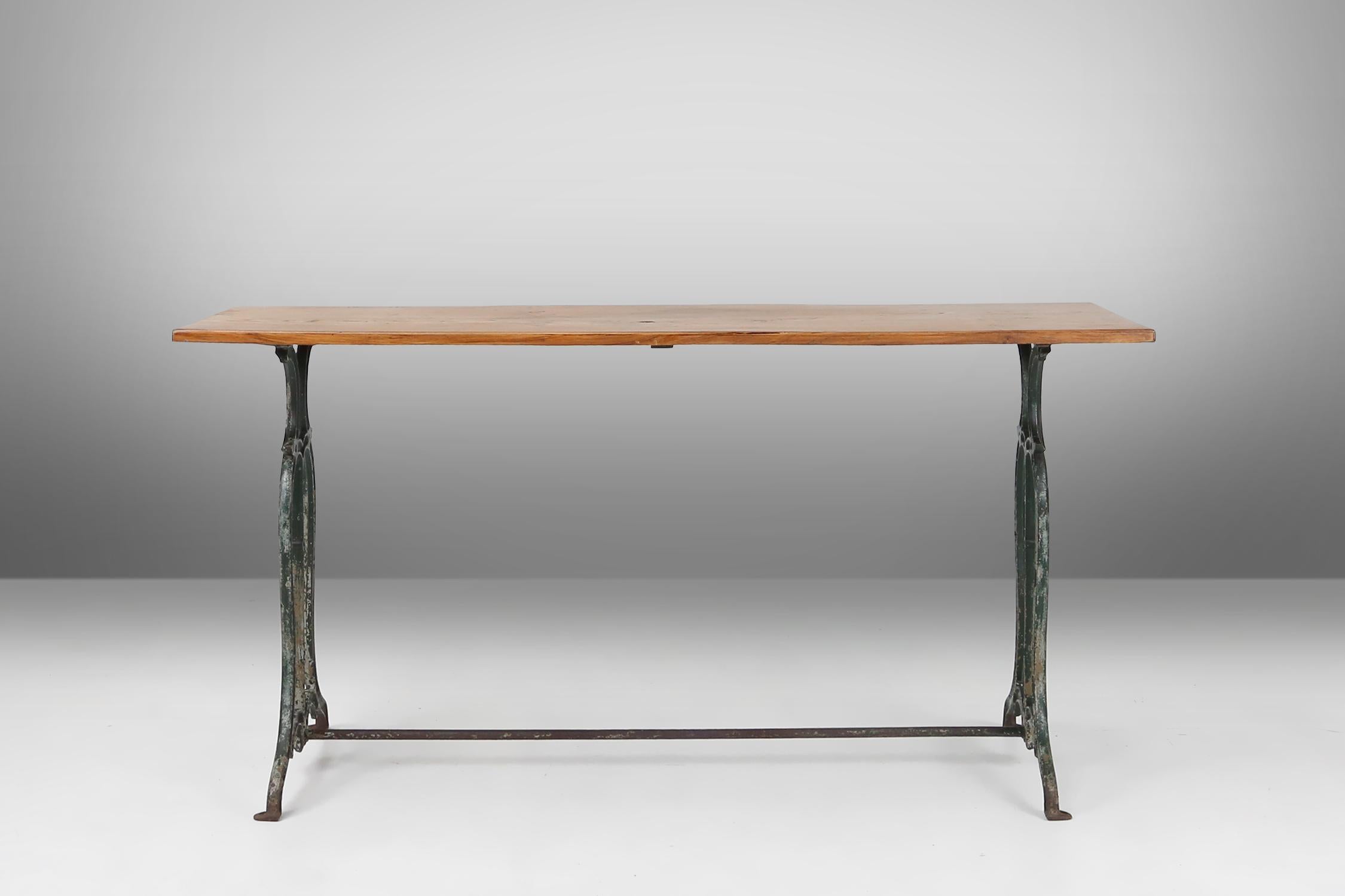 Rustic French bistro table with elegant metal base and oak top, ca. 1890 For Sale