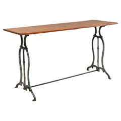 Antique French bistro table with elegant metal base and oak top, ca. 1890