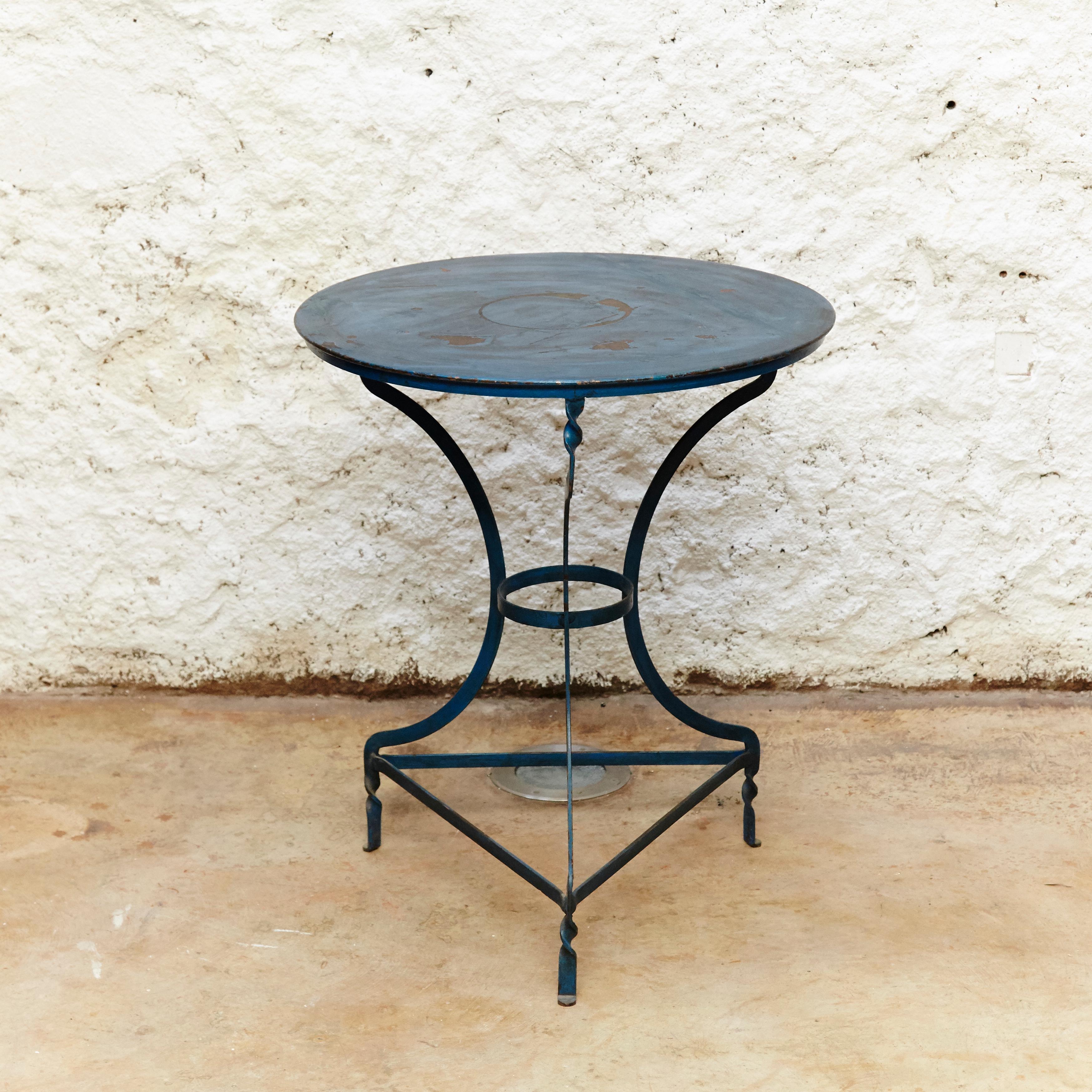 Bistrot table,
Manufactured in France, circa 1930.
Lacquered blue metal.

In original condition with wear consistent of age and use, preserving a beautiful patina. With some traces of rust as shown on the photos.