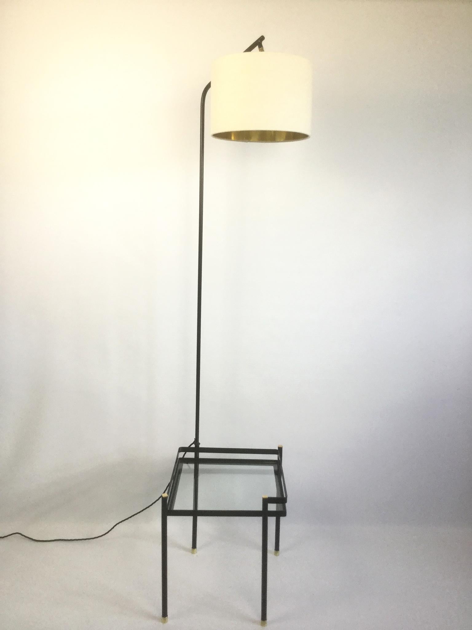 Elegant 1950s, floor lamp with a side table in a spirit of Mathieu Mategot.
The lamp can swivel around the side table.
Recently covered with black enamel paint.
With the original beautiful brass finish on the top and on the table legs
New top