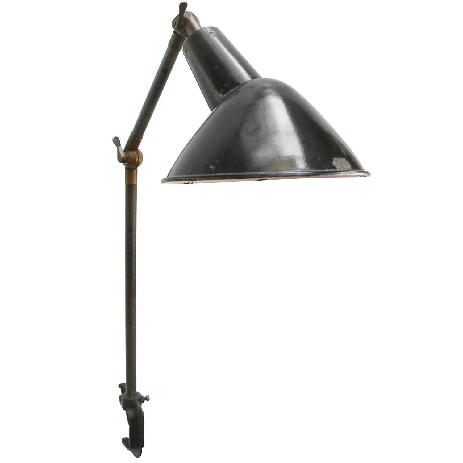 French Holophane Black Enamel Vintage industrial 2-arm machinist work table lamp
Cast iron clamp and arm. Brass joints.
Adjustable in height and angle.
Including plug and switch

Available with UK / US plug

Weight: 3.30 kg / 7.3 lb

Priced per