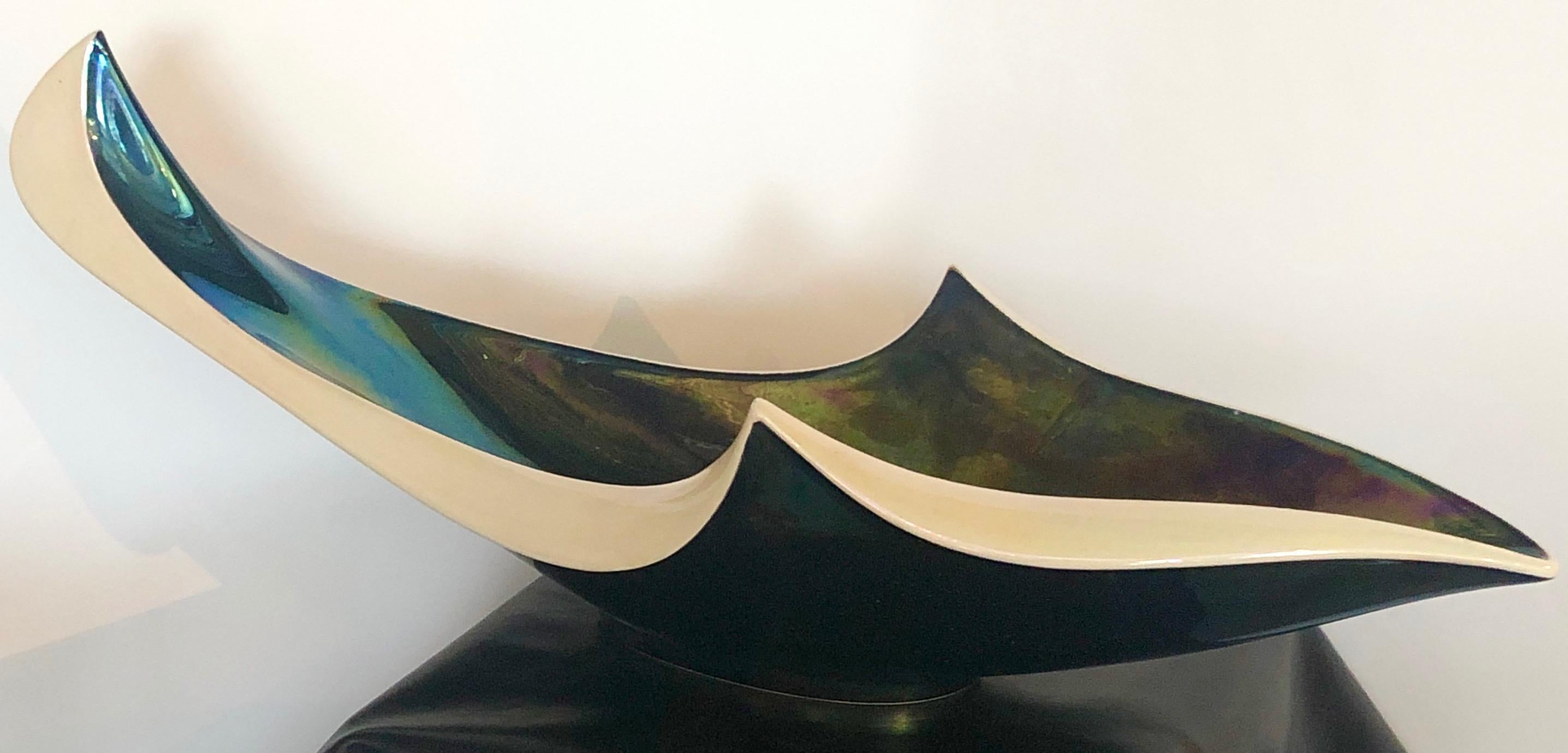 Offered is a Mid-Century Modern French glazed ceramic abstract (probably sea-life theme) decorative or art large bowl. Due to the glazing process, the exterior of the bowl is an iridescent color spectrum of blue, green, yellow and red. The exterior