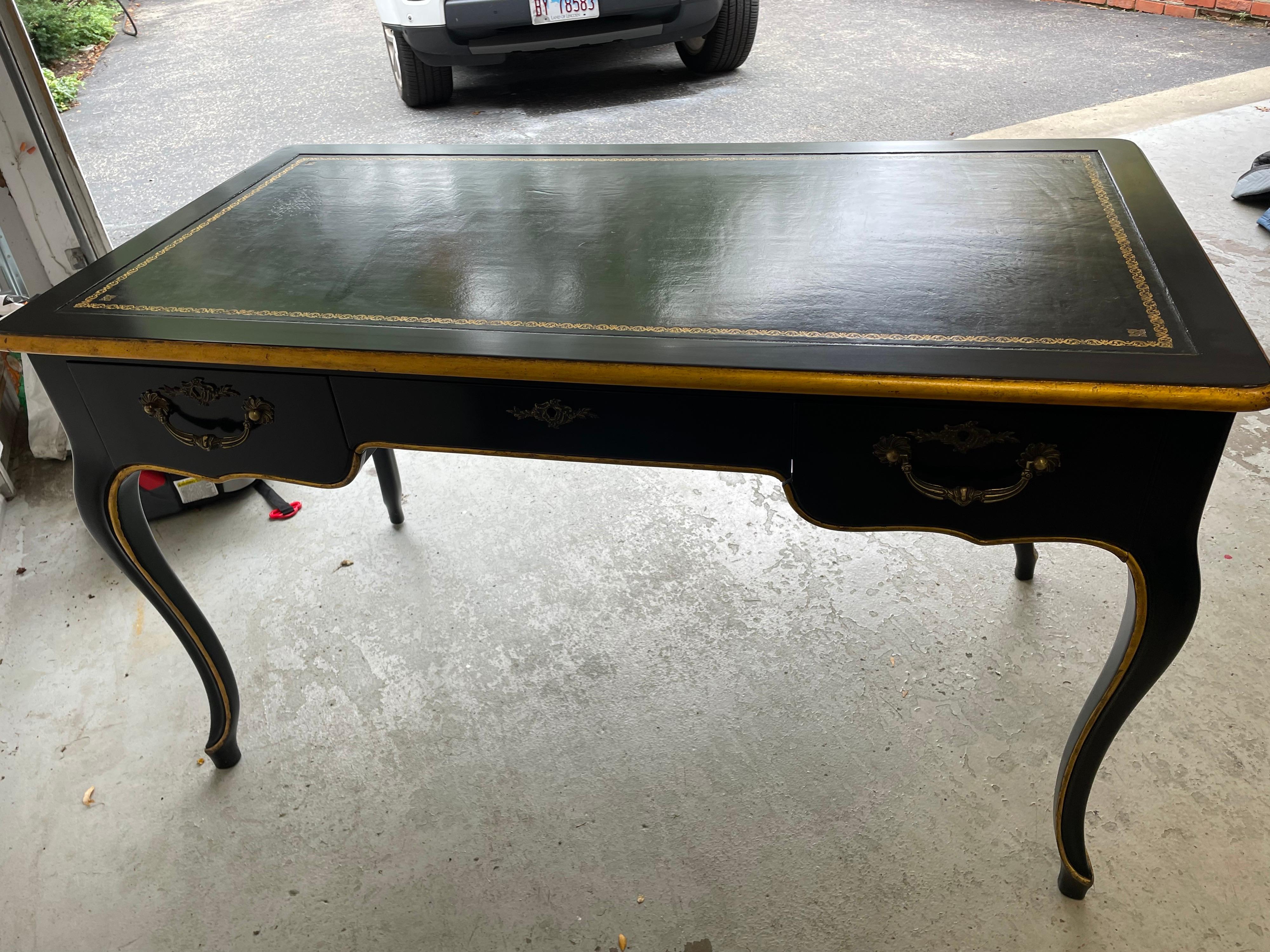 This is a wonderful French style Black laquer and gold trim writing desk, with an inset of black embossed leather.