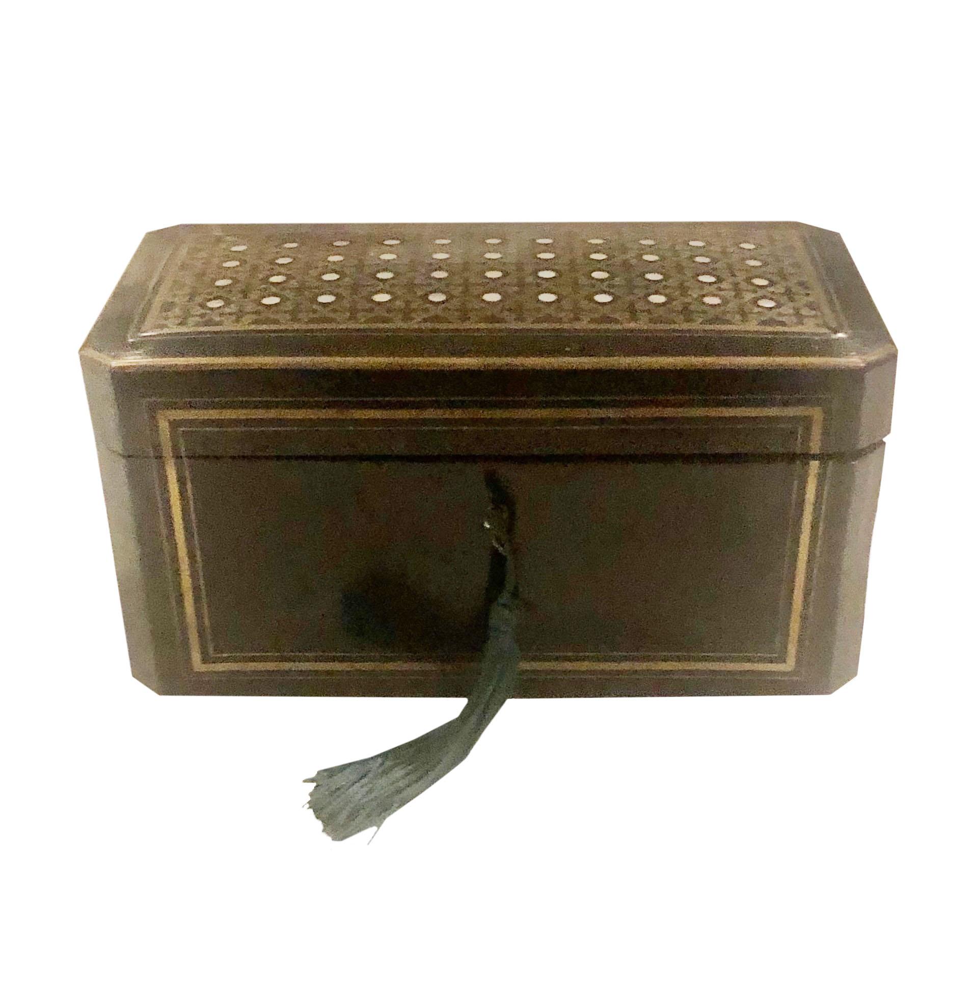 A beautiful tea caddy with original key and original interior it is black lacquer, mother of pearl and has a brass inlay design all over the box. 19th century, France.