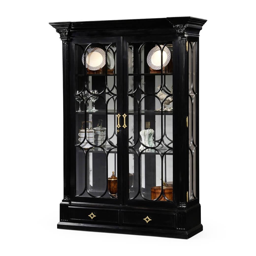 Large French neoclassic black lacquered display cabinet with mirrored interior and adjustable lighting, the glazed doors flanked by fluted Corinthian columns. Two shallow drawers to the base, and stylised geometric brass handles. Range sensitive