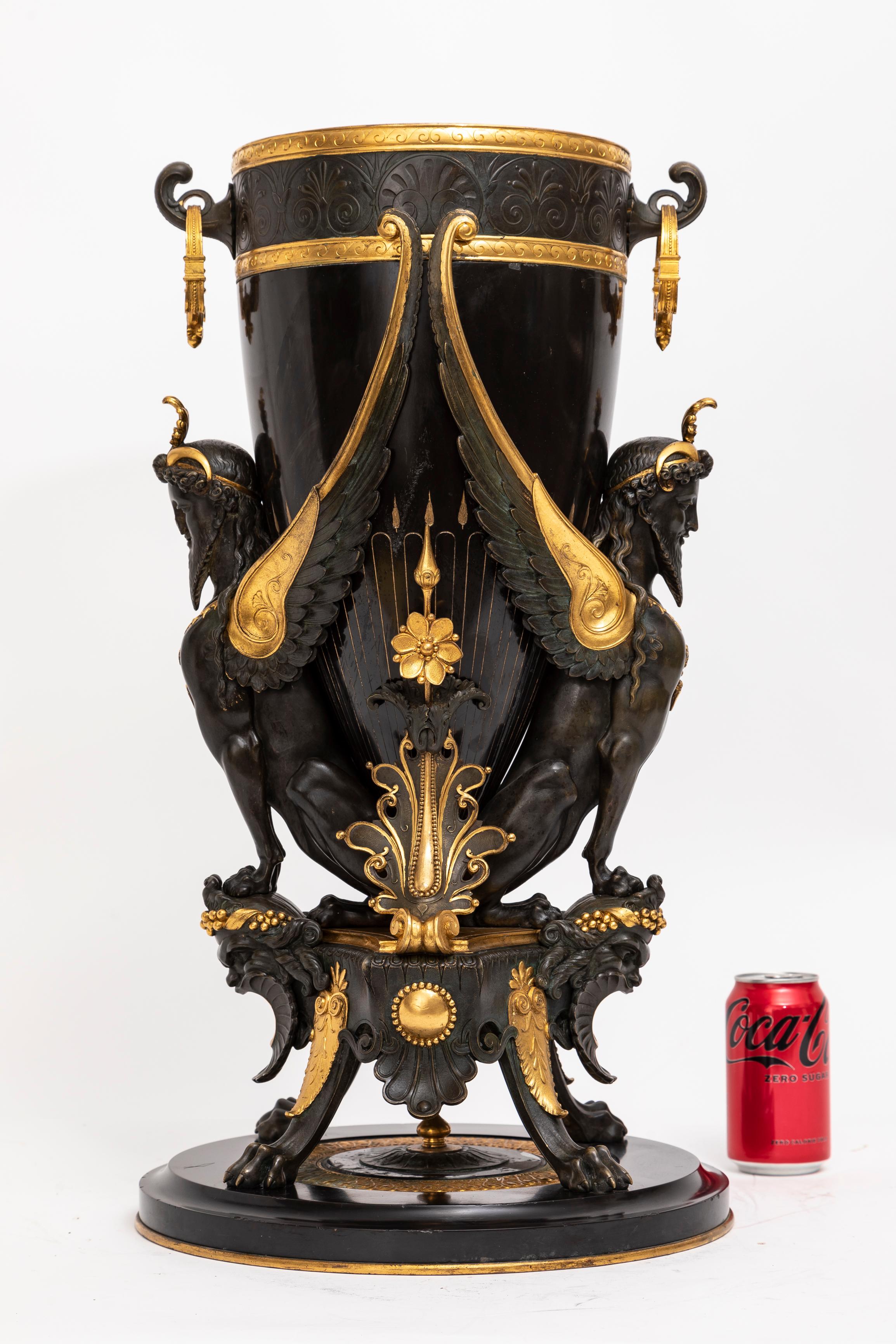 A Large 19th Century French Black Marble, Patinated, and Gilt-Bronze Vase Attributed to Charpentier & Cie.  This remarkable vase is attributed to the workshop of Charpentier & Cie., and stands as an exquisite fusion of sumptuous black marble,