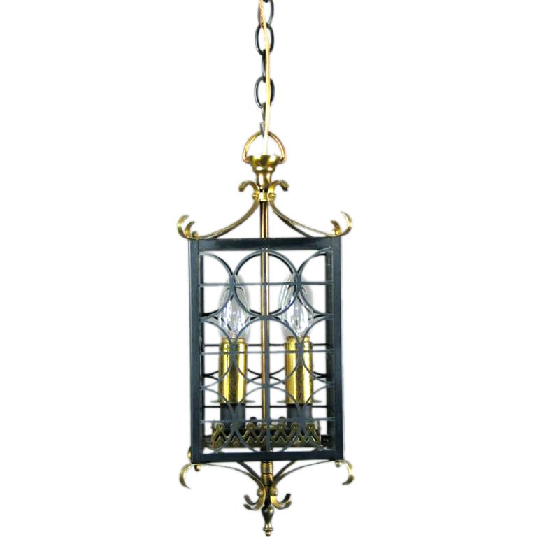 A four panels black metal and polished brass lantern. Two light.