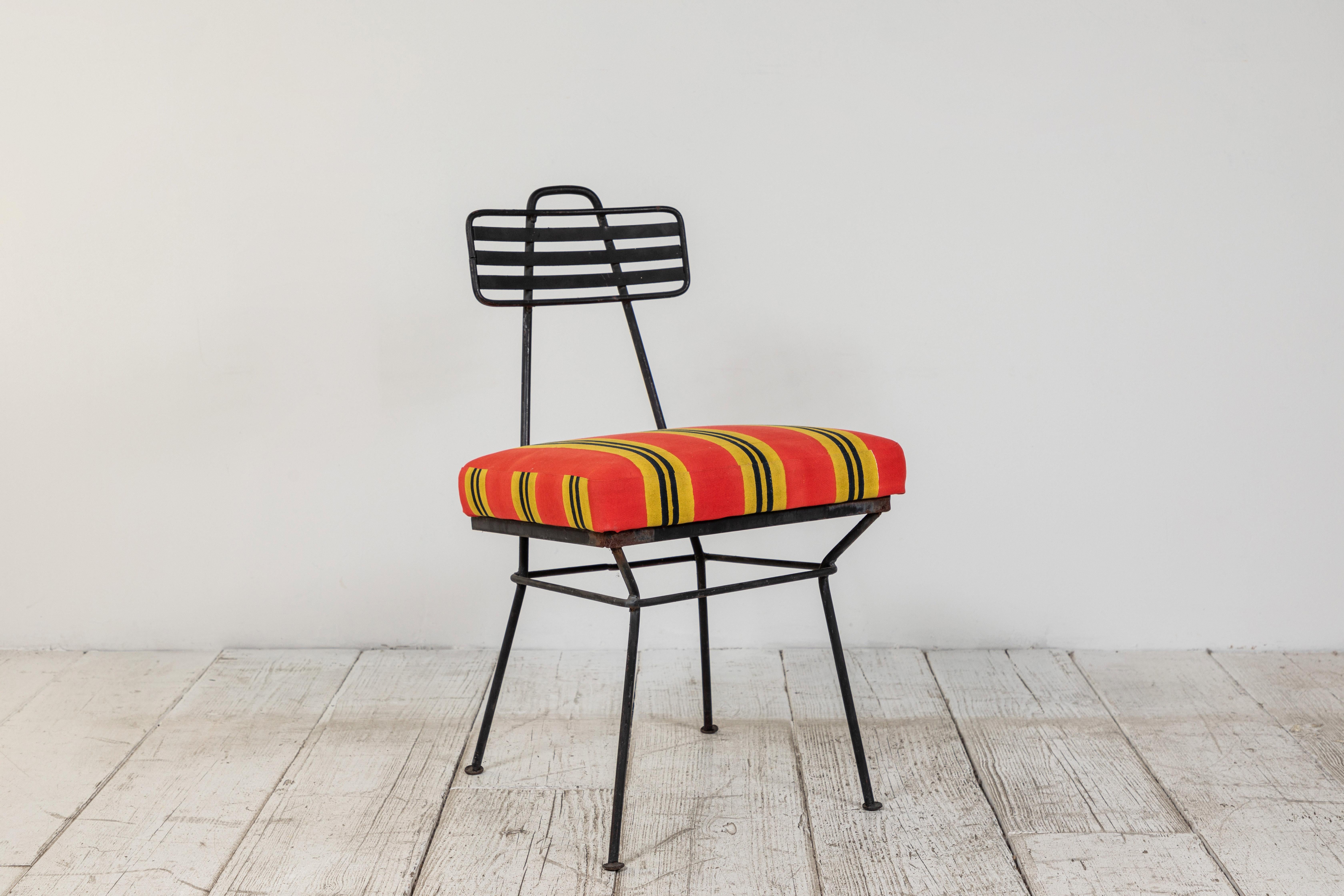 French metal garden chair newly upholstered in a Lisa Corti orange yellow and black canvas.