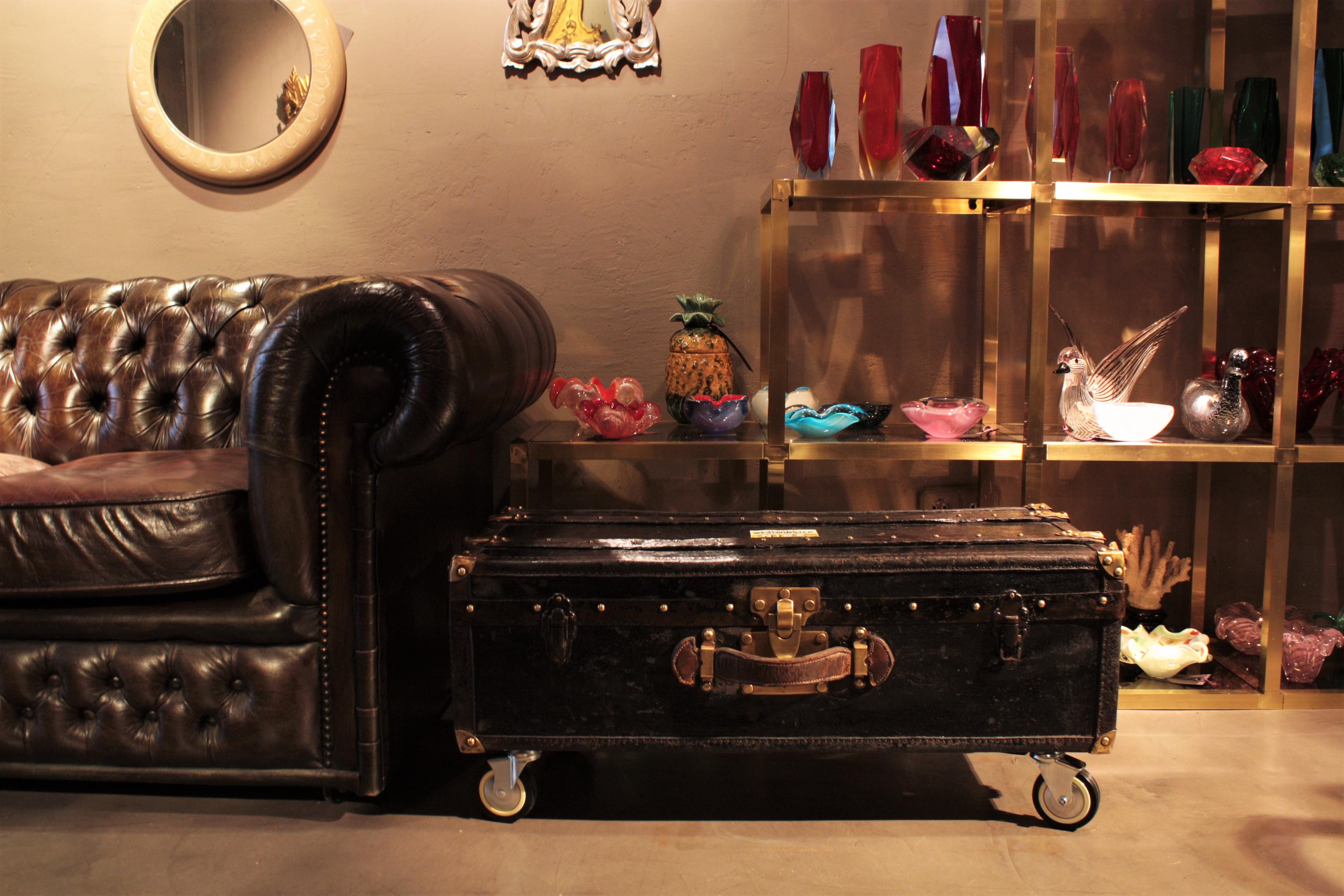 Beautiful black canvas and leather trunk as coffee table / side table. France, 19th century.
This trunk is all made in wood covered with black canvas. It has wooden bars, leather protections, studs and fittings in brass and a brown leather handle