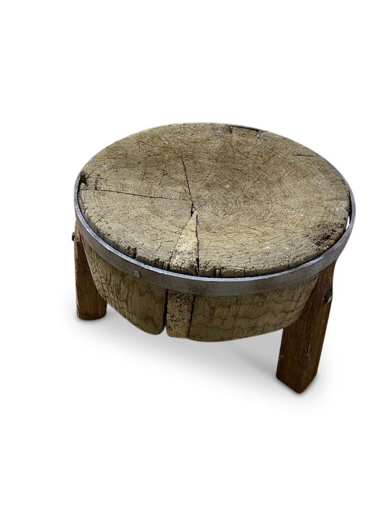 19th Century French super-sized, solid Blacksmiths log with centuries of patina and wear. 
A solid steel ring supports the block mounted within three sturdy legs and will now make a fantastic coffee table.

 