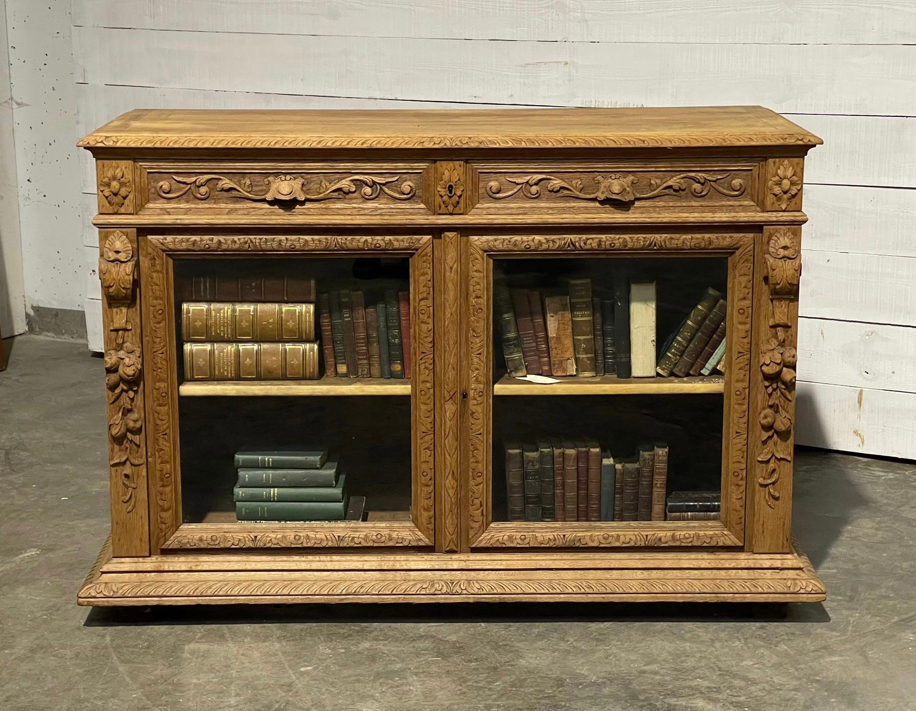 A rare French carved oak low bookcase. Having 2 glazed doors to the front with 2 drawers above. Made from solid oak in the 19th century. We have bleached it for a fresh look and it brings out all the wonderful hand carved decoration.
In excellent