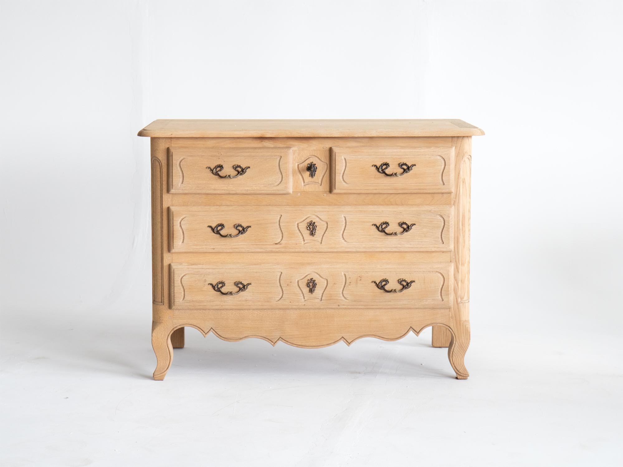 A bleached oak commode or chest of two short over two long drawers in the Louis XV taste. French, 1970s.