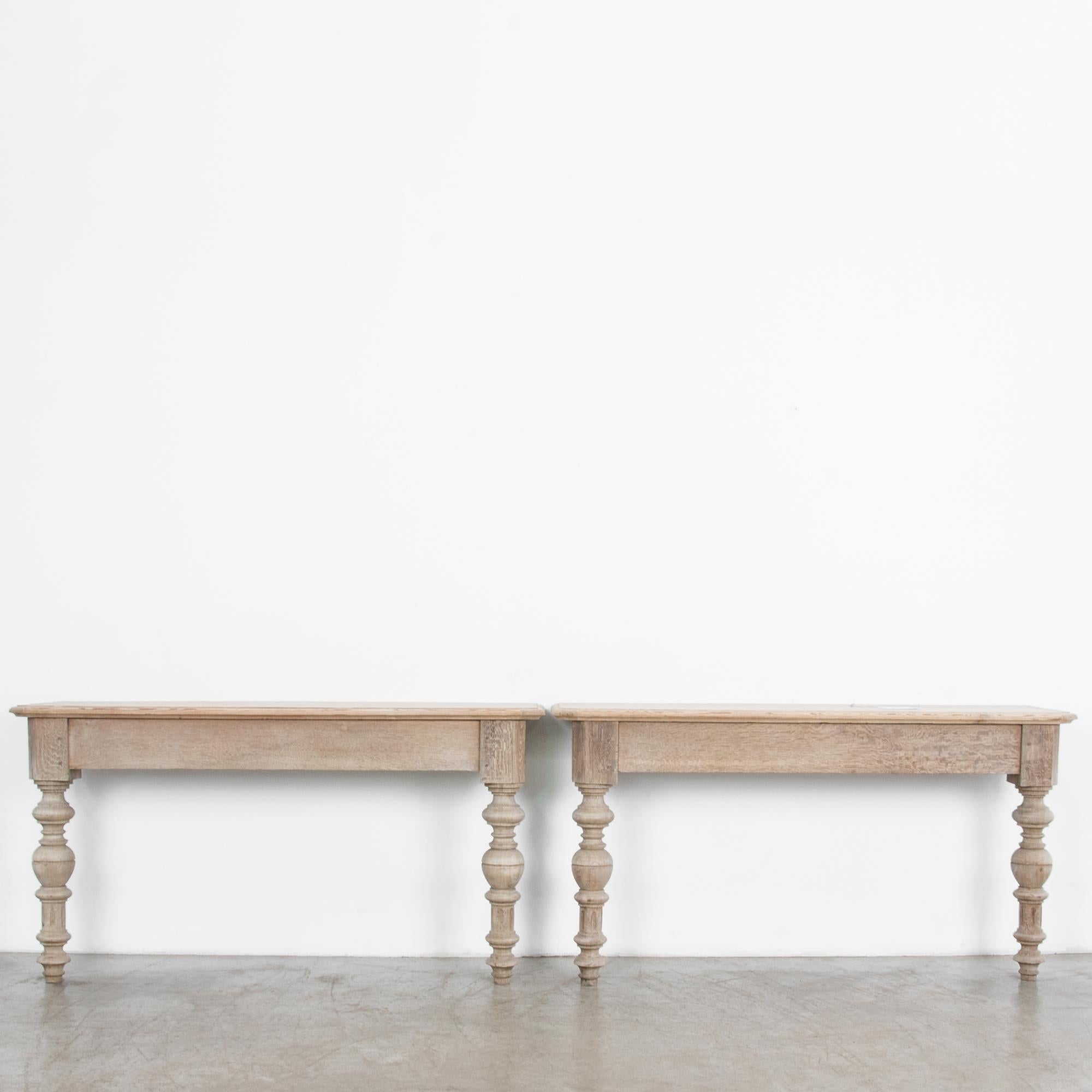 Two Louis XVI style oak wall mount console tables from circa 1880, France. A French provincial construction in rustic oak, masterfully crafted in Parisian style, with a decades delay to the provinces. Turned and carved legs, with geometric ornament