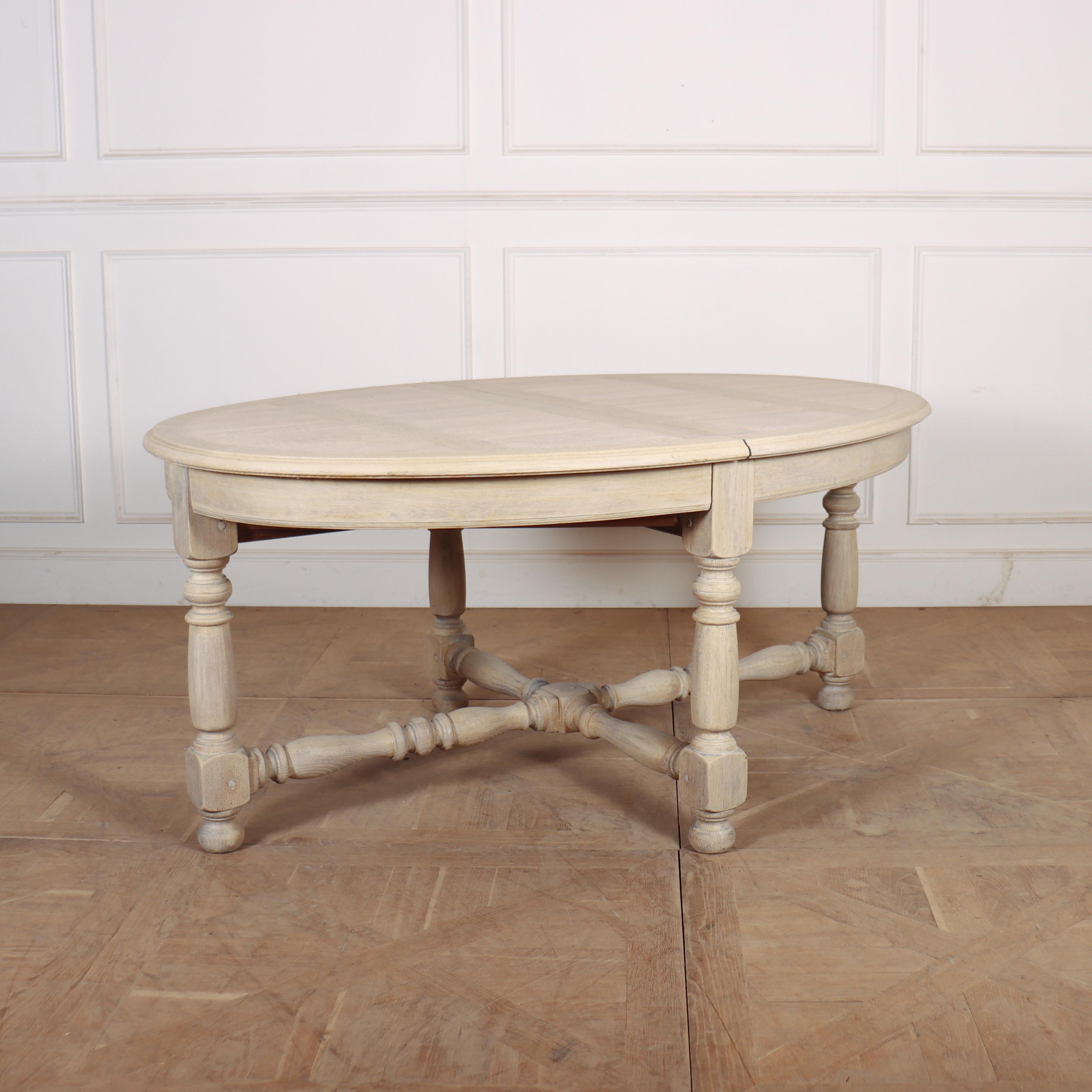 Unusual 19th century bleached oak French oval dining table with 4 individual leaves measuring 15
