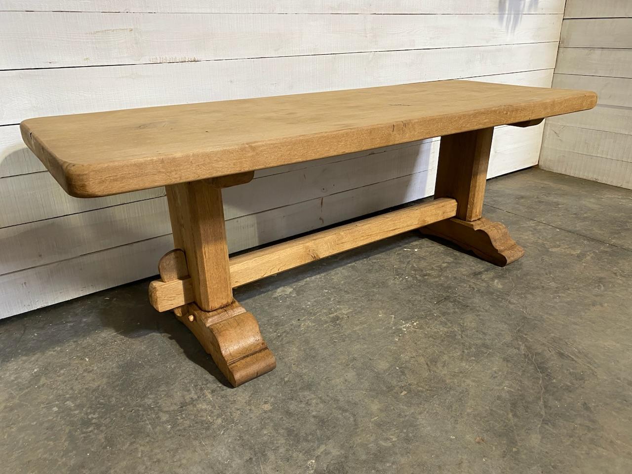 A more Rustic Looking French Farmhouse dining table dating to the early 1900s and made of solid Oak. The top is thick and very heavy. We have bleached it to bring out the natural beauty of the wood and for a fresh look. The table comes apart for
